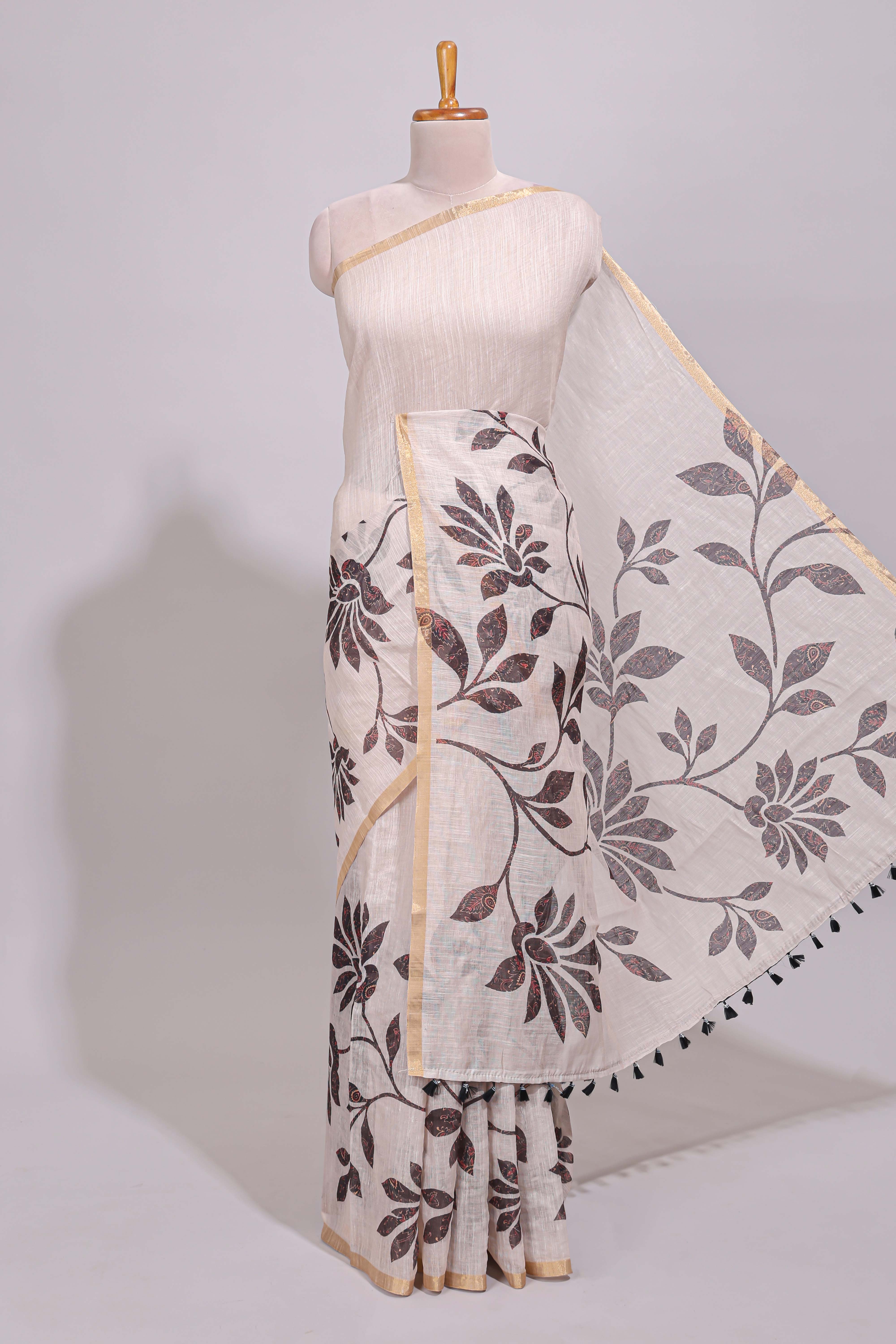 Cream floral design linen cotton saree with self zari border and contrast printed blouse