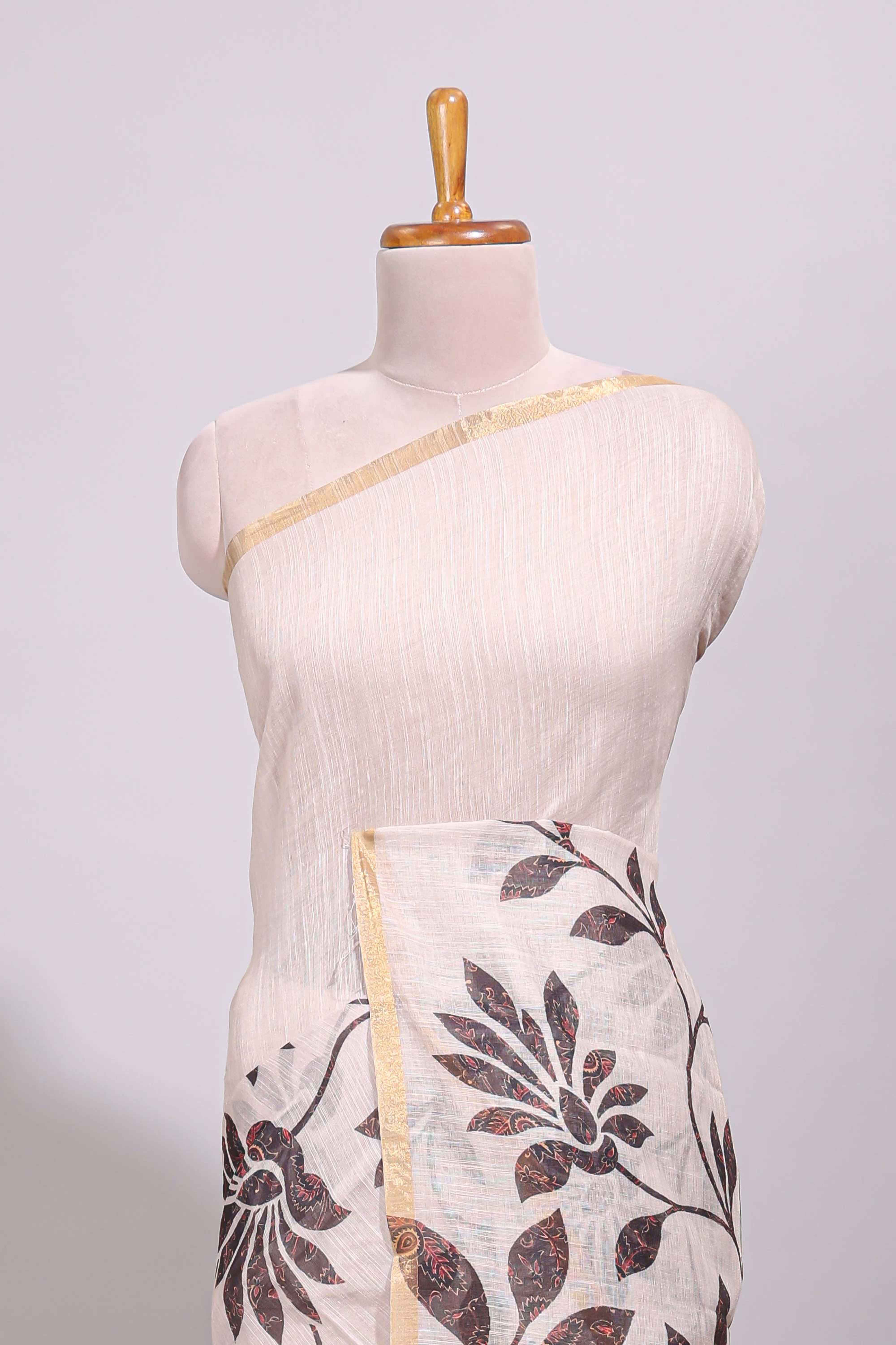 Cream floral design linen cotton saree with self zari border and contrast printed blouse