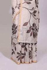 Cream floral design linen cotton saree with self zari border and contrast printed blouse