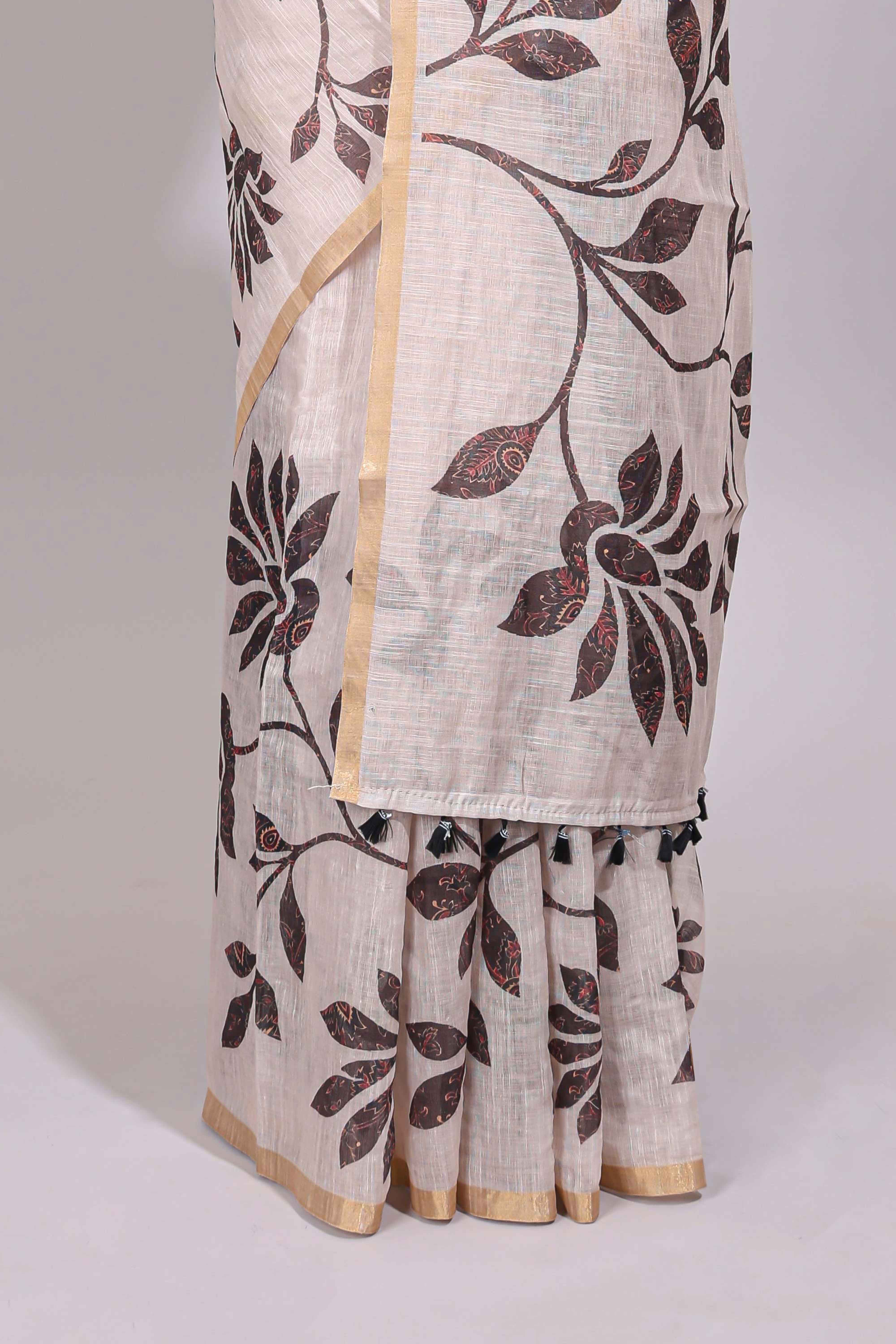 Cream floral design linen cotton saree with self zari border and contrast printed blouse