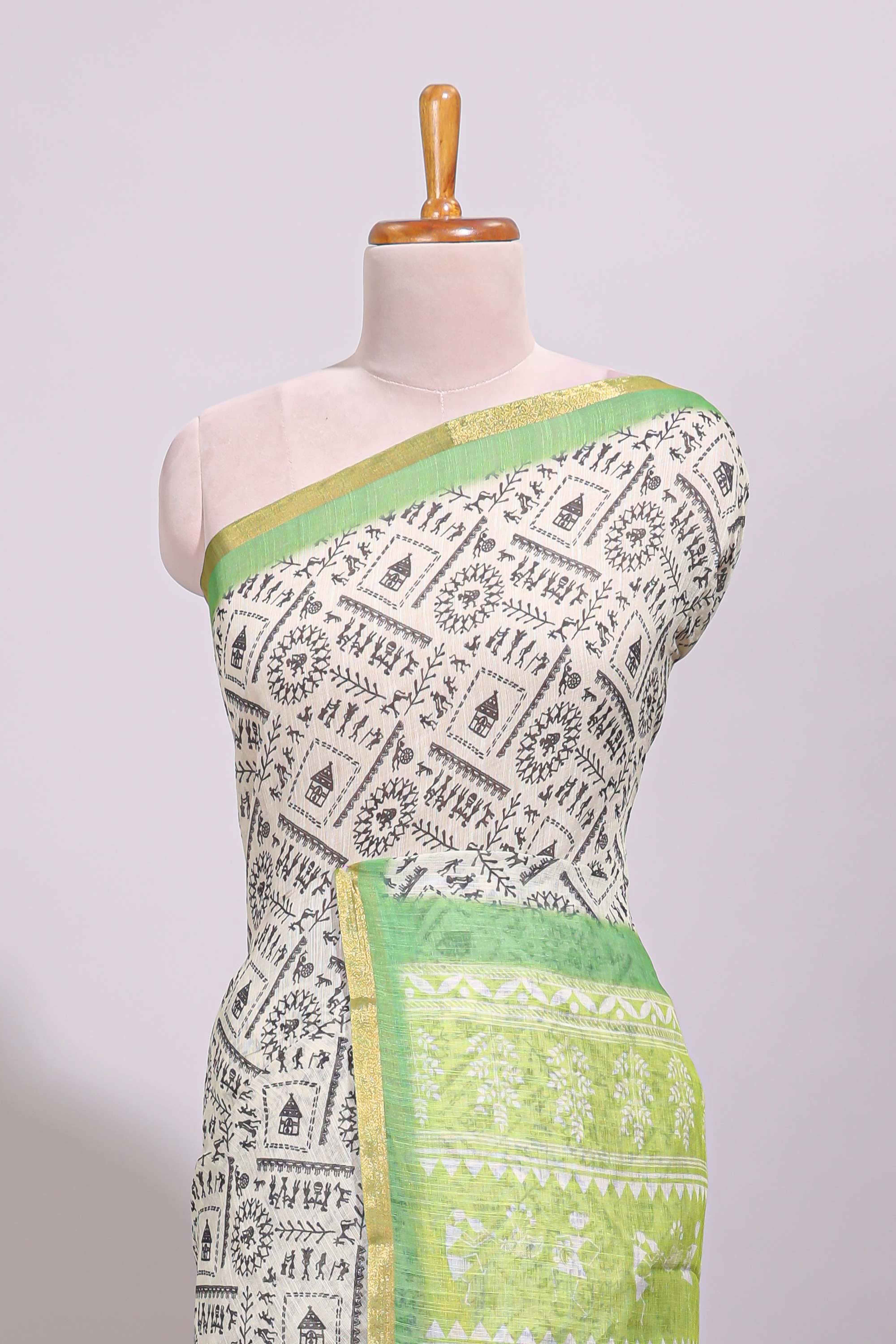 Cream warli design linen cotton saree with contrast zari border and printed blouse