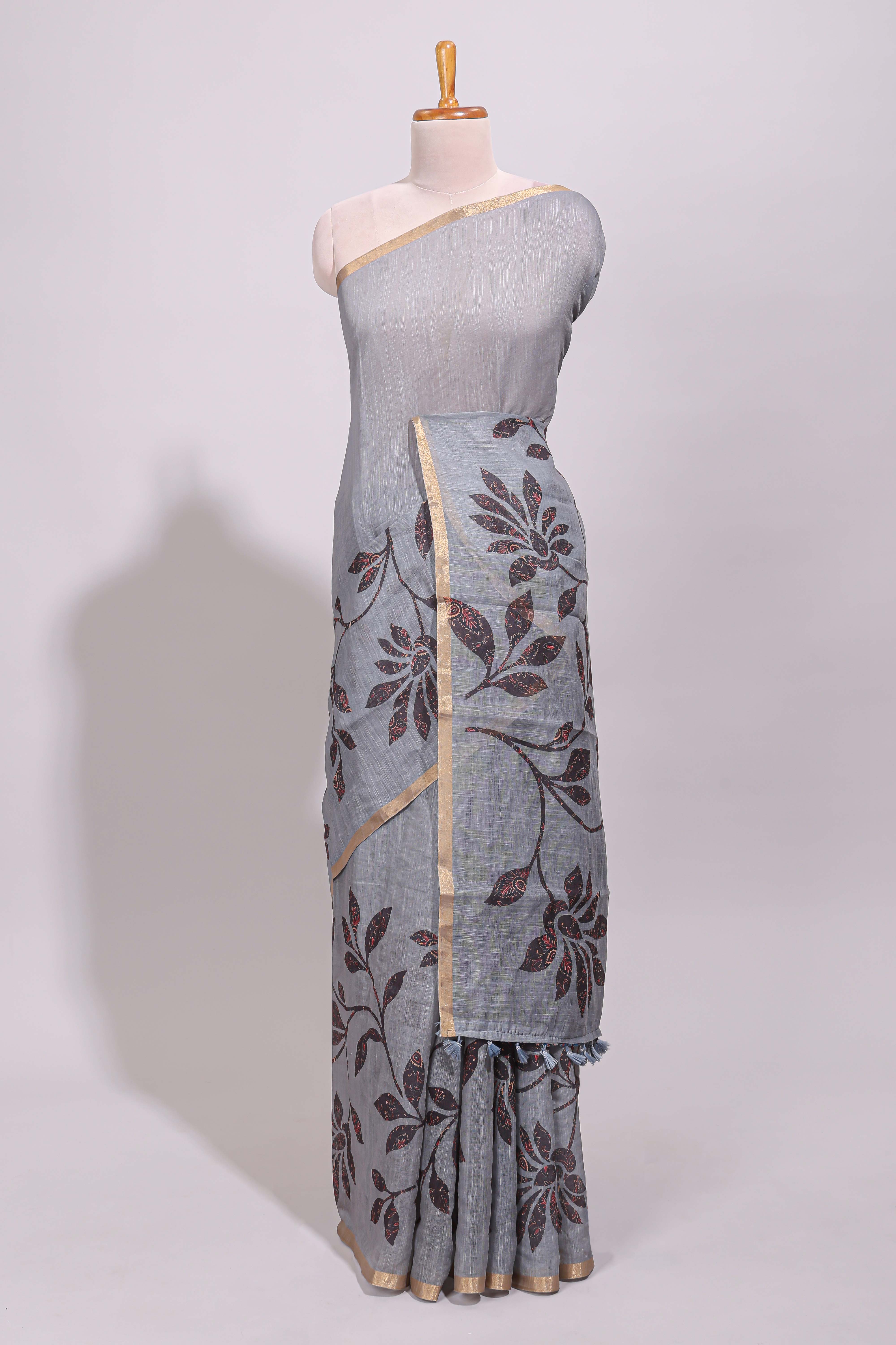 Grey floral design linen cotton saree with self zari border and contrast printed blouse