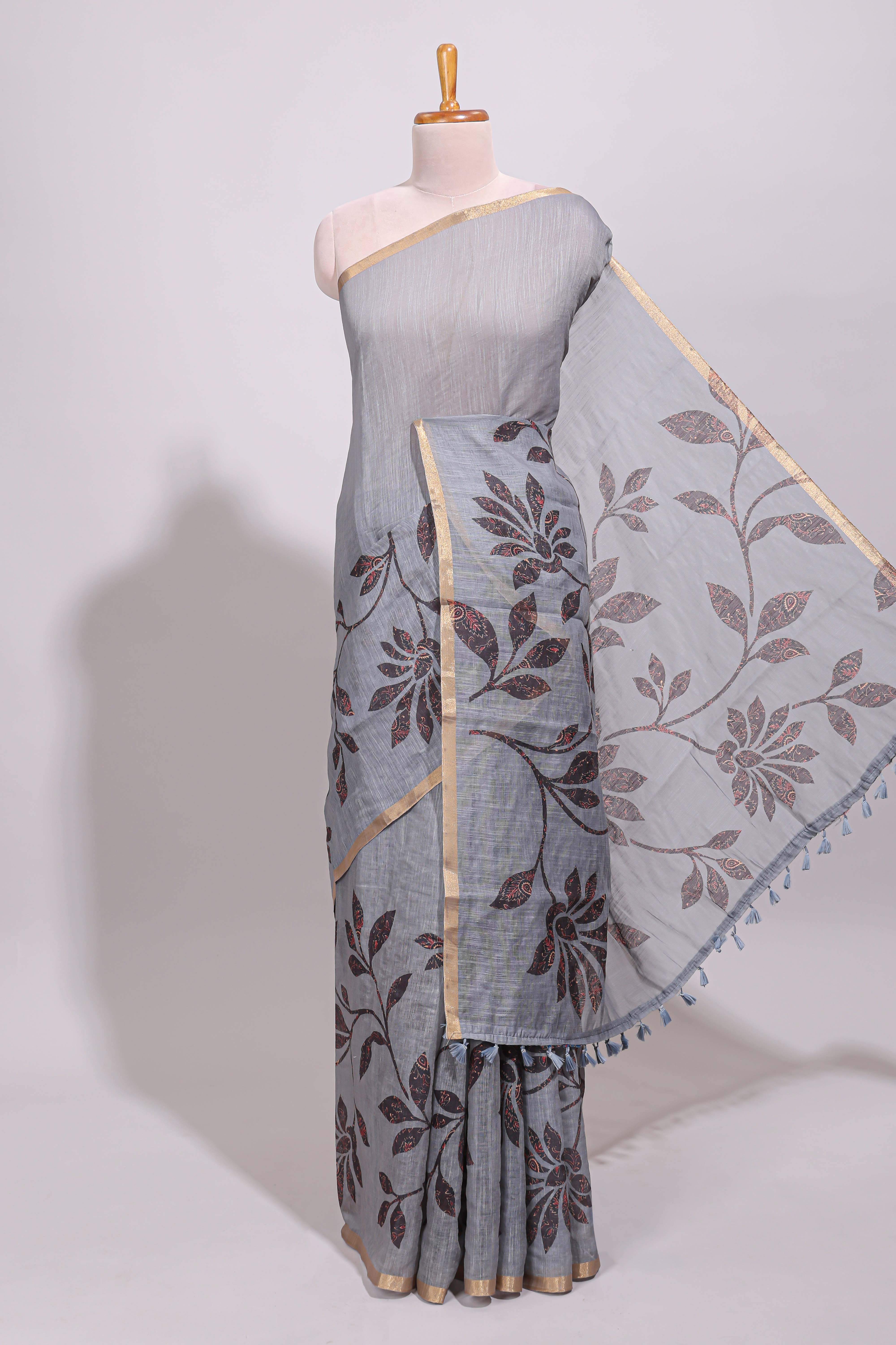 Grey floral design linen cotton saree with self zari border and contrast printed blouse