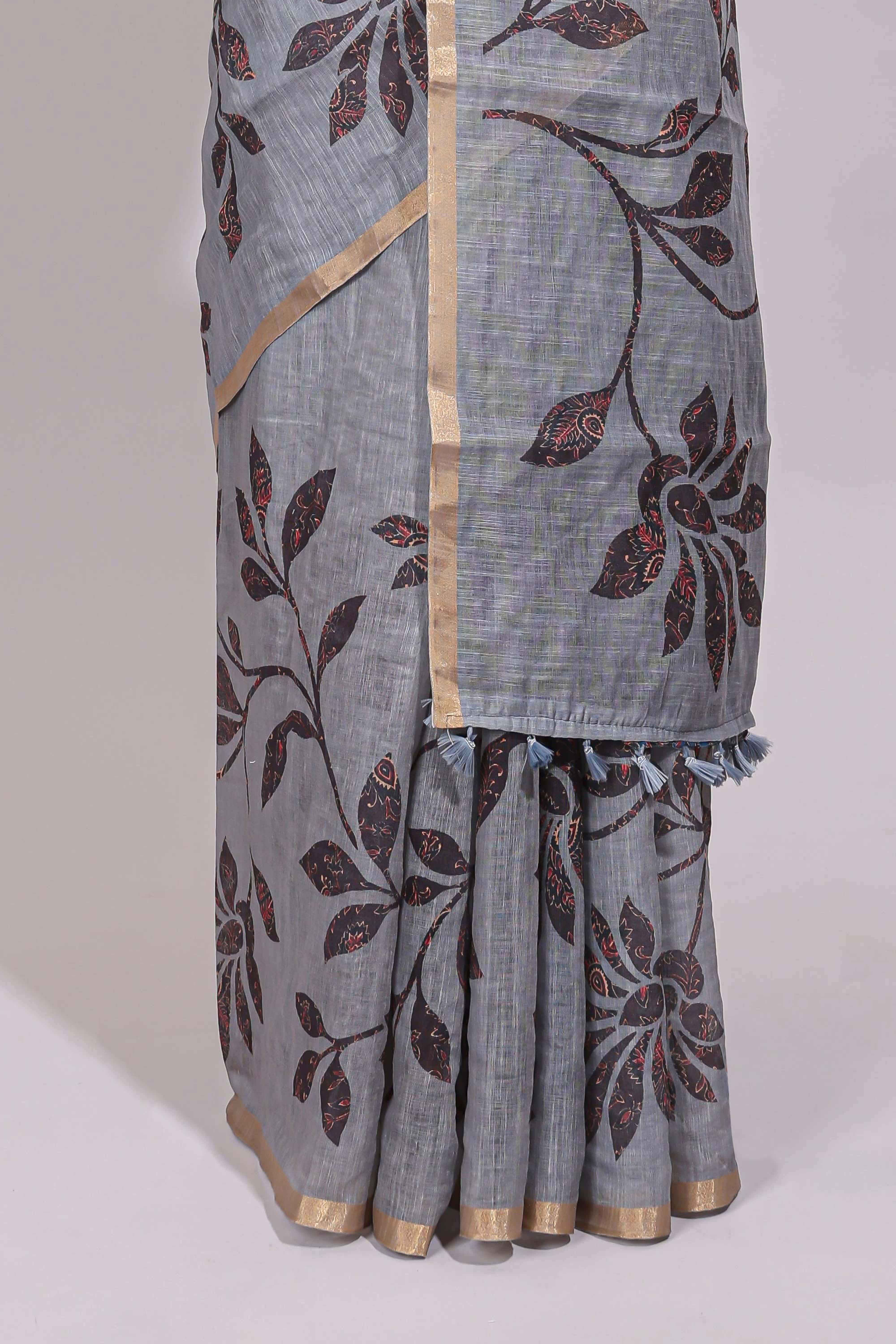 Grey floral design linen cotton saree with self zari border and contrast printed blouse