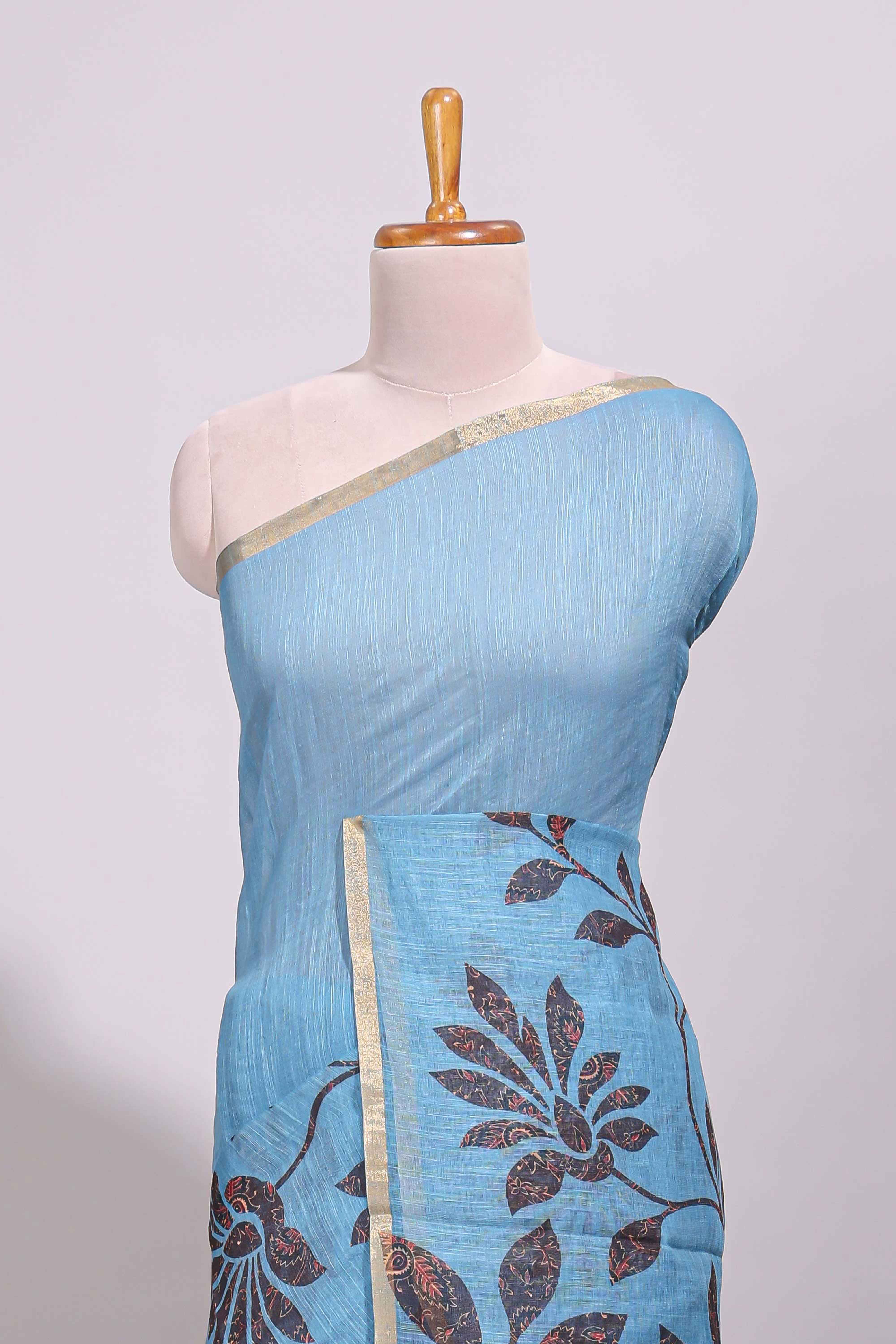 Blue floral design linen cotton saree with self zari border and contrast printed blouse