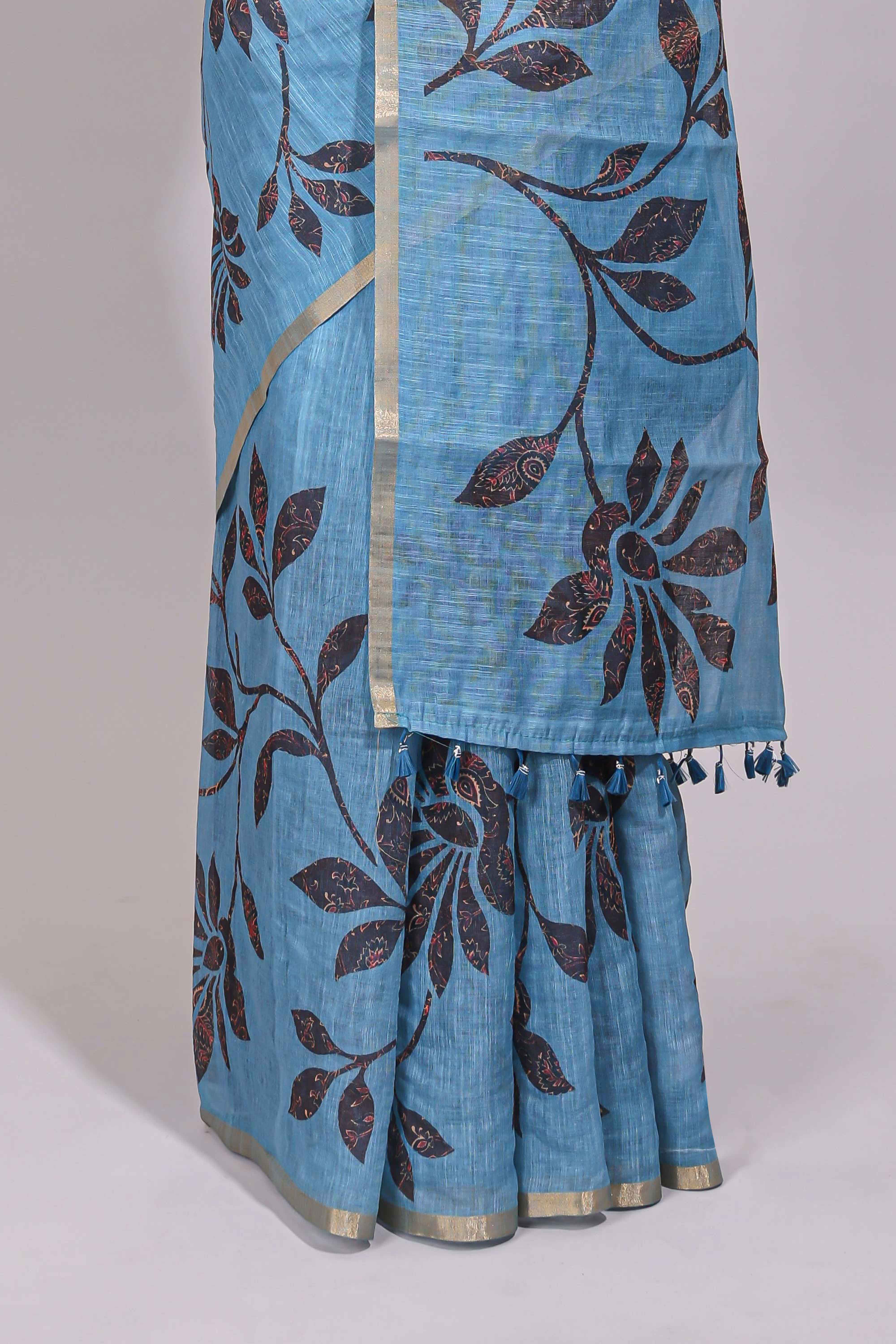 Blue floral design linen cotton saree with self zari border and contrast printed blouse