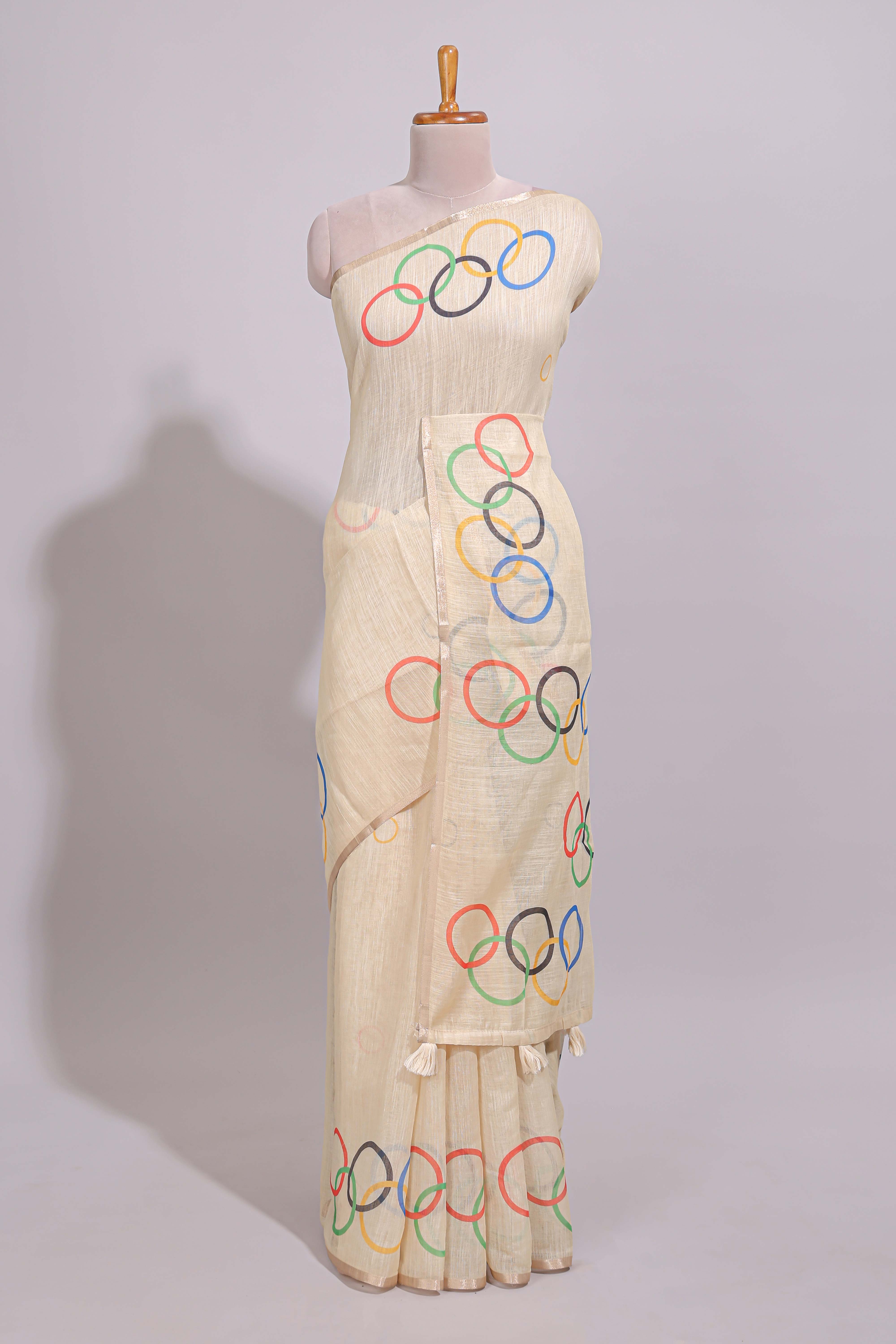 Cream olympic logo design linen cotton saree with self zari border and matching printed blouse
