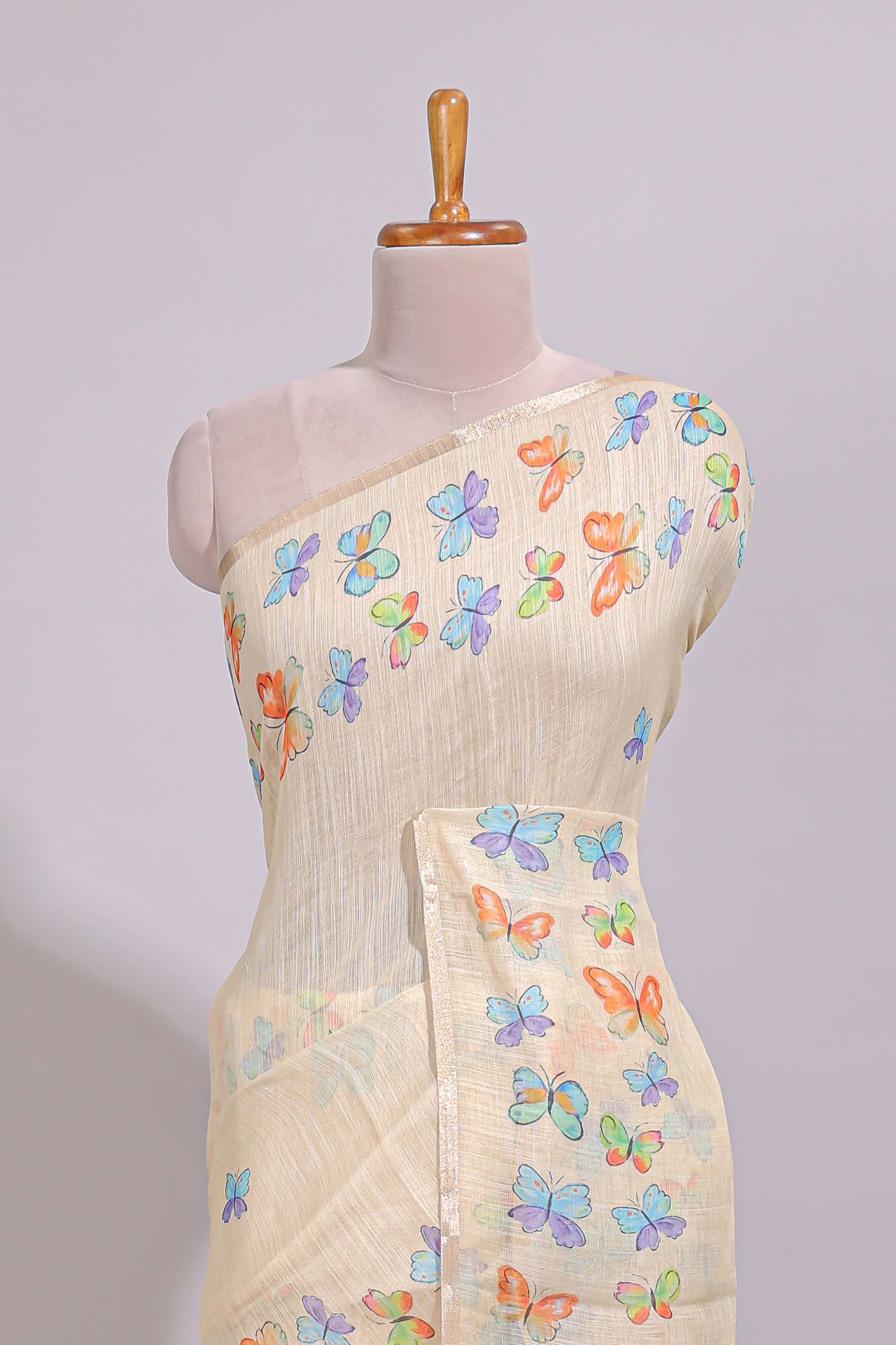 Cream butterfly motifs linen cotton saree with self zari border and matching printed blouse