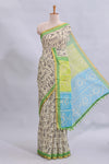 Beige tribal design warli print linen cotton saree with contrast green zari border and chevron design blouse