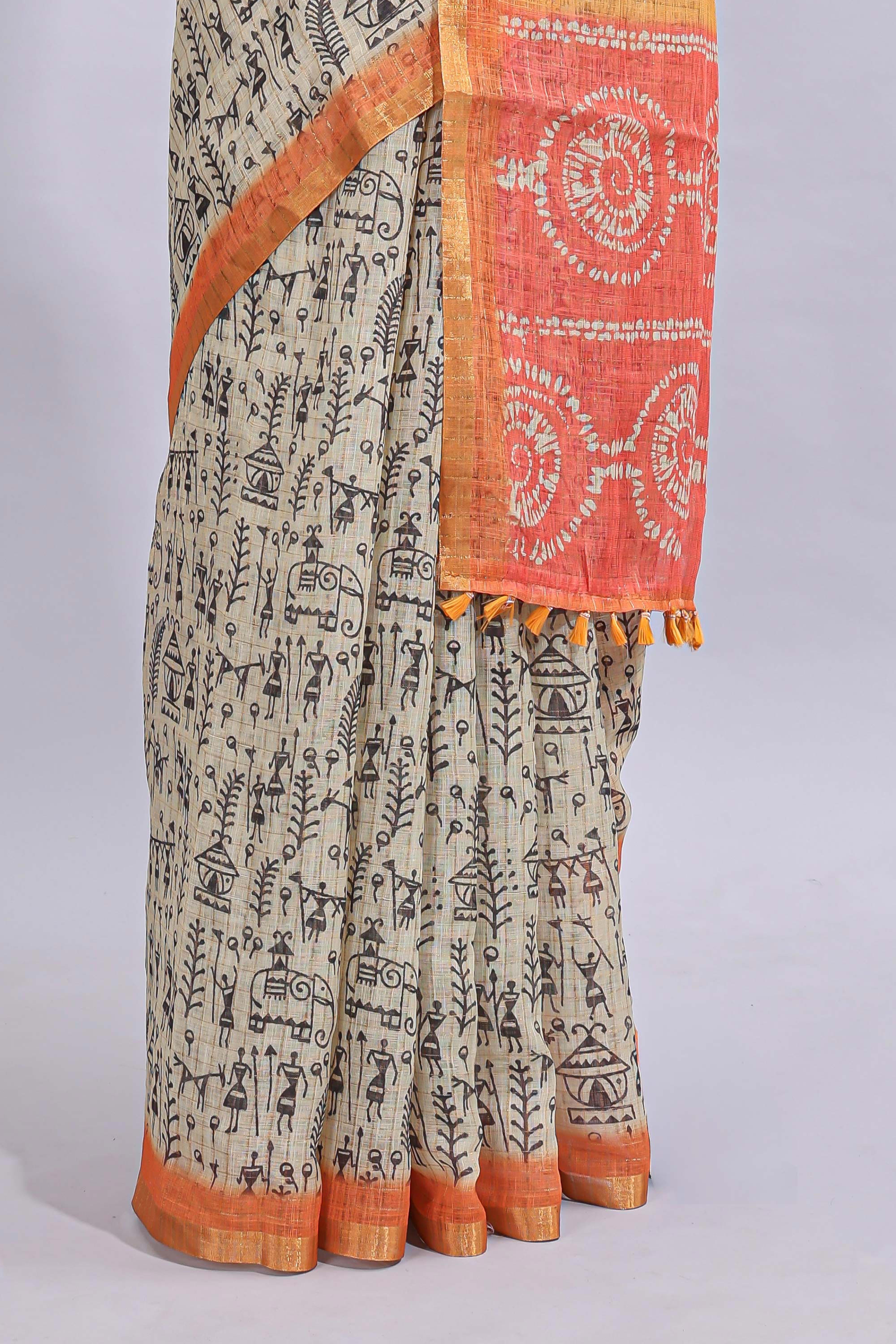Beige tribal design warli print linen cotton saree with contrast orange zari border and warli design blouse