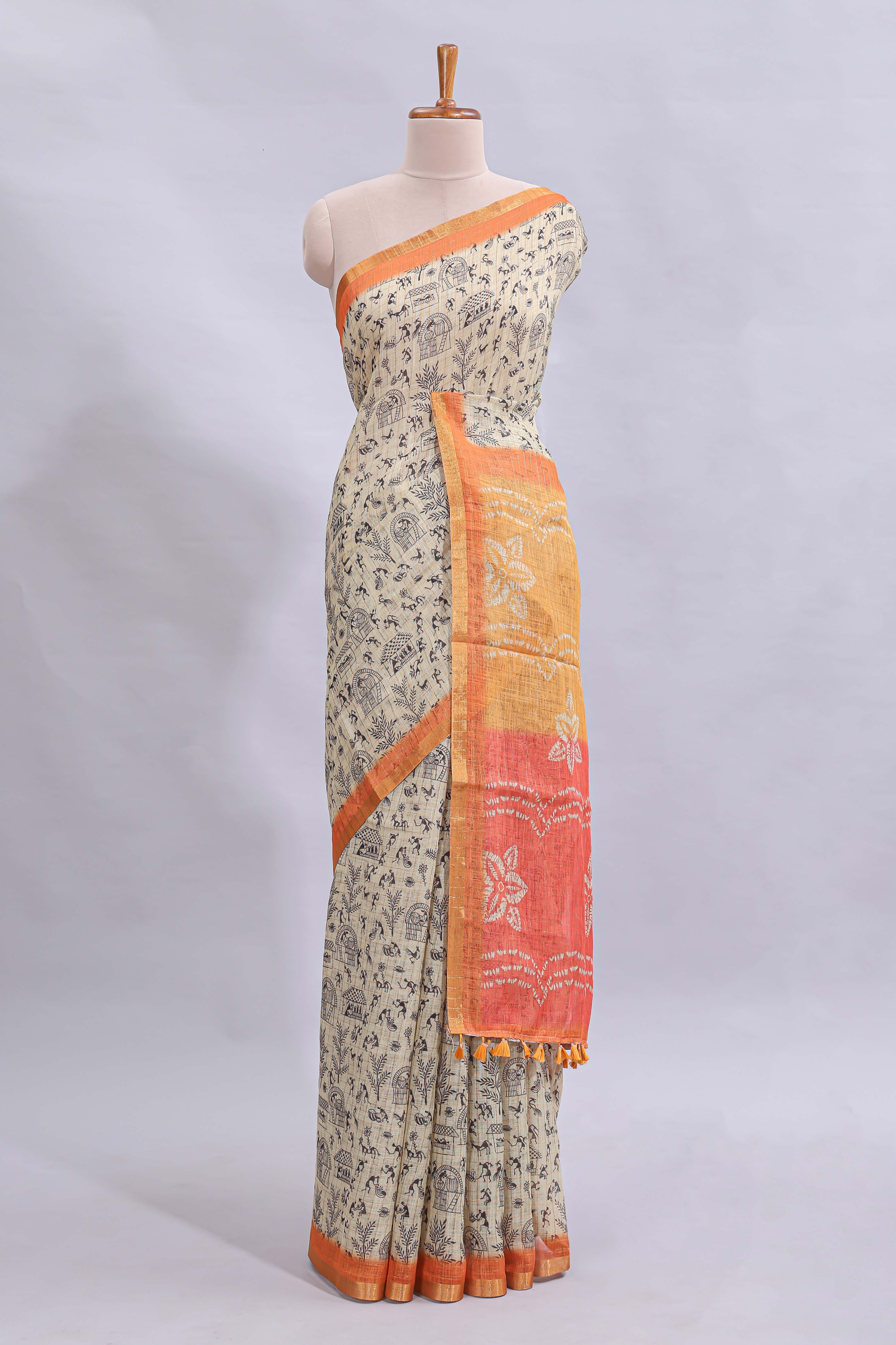 Beige tribal design warli print linen cotton saree with contrast orange zari border and floral design pallu