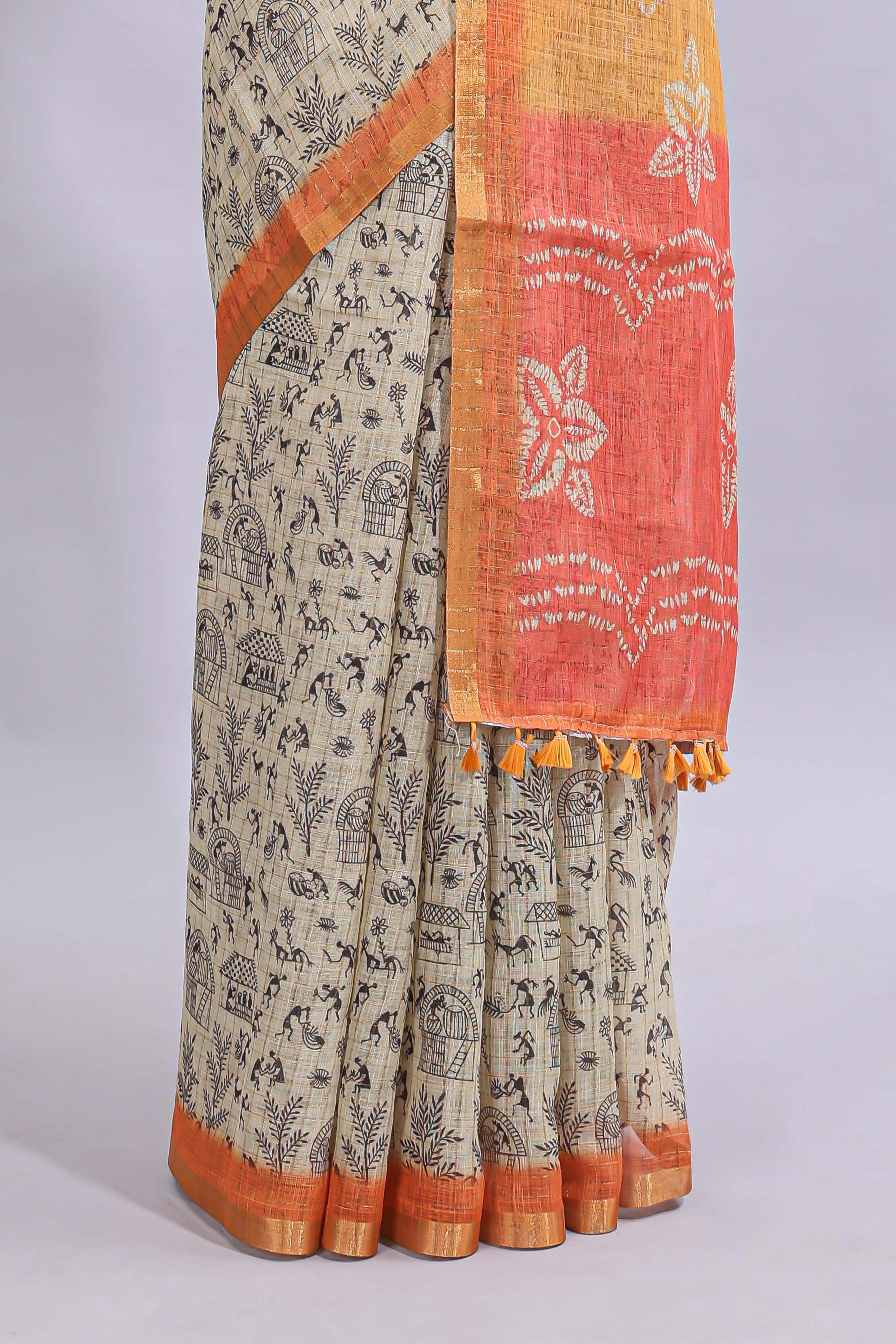 Beige tribal design warli print linen cotton saree with contrast orange zari border and floral design pallu