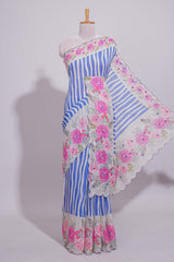 White Linen saree with blue stripes and vibrant pink floral scallop border with contrast printed blouse