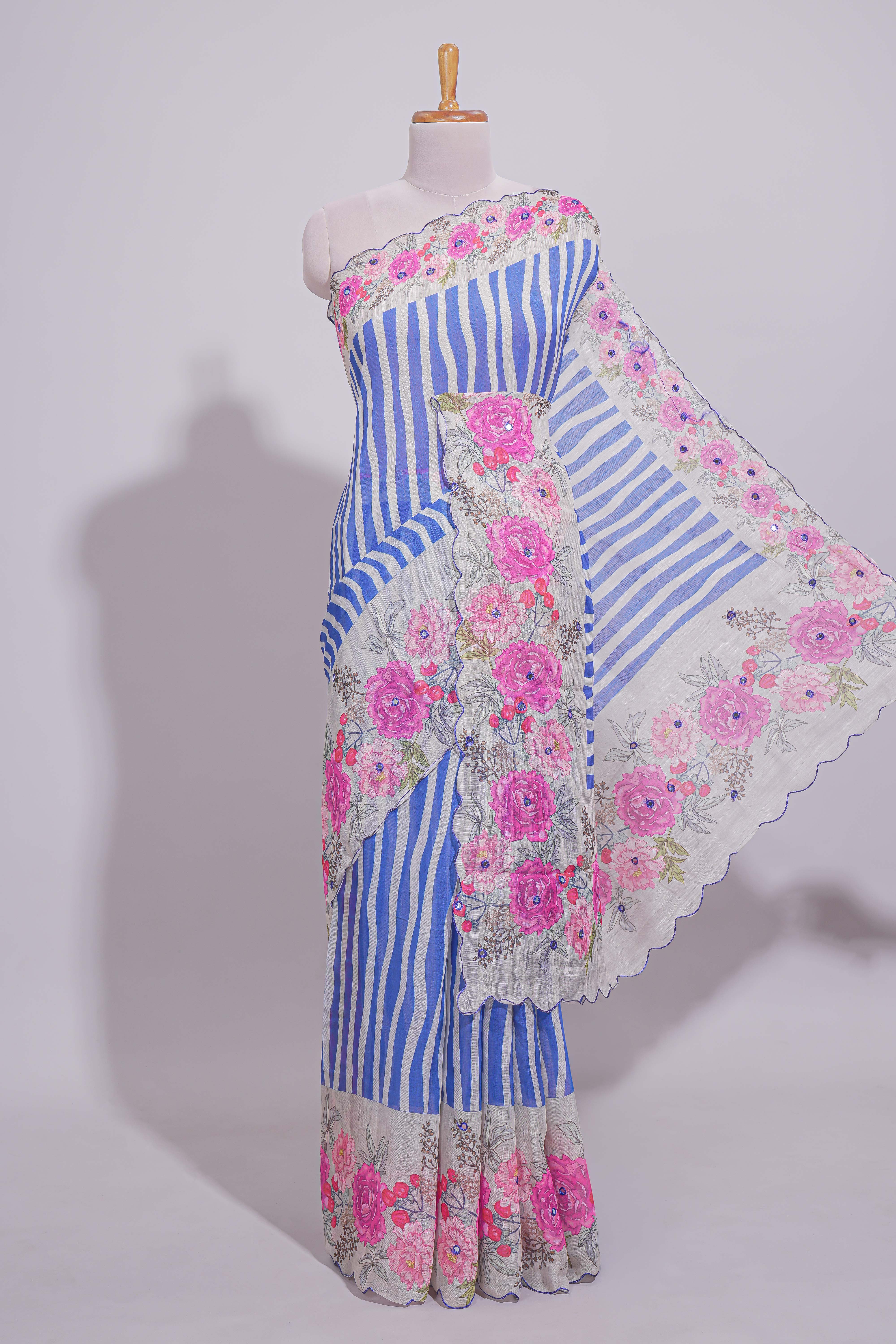 White Linen saree with blue stripes and vibrant pink floral scallop border with contrast printed blouse