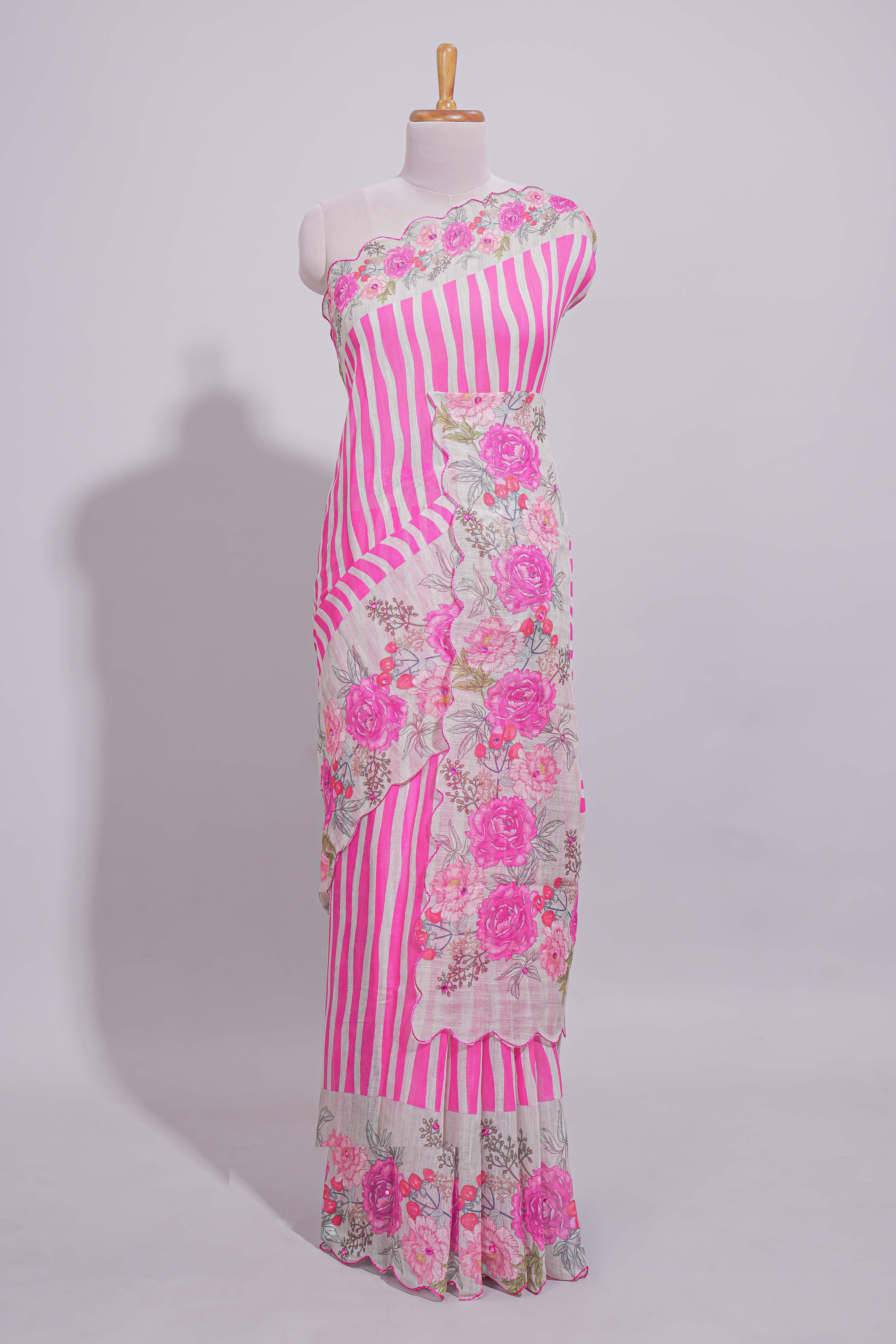 White Linen saree with pink stripes and vibrant pink floral scallop border with contrast printed blouse