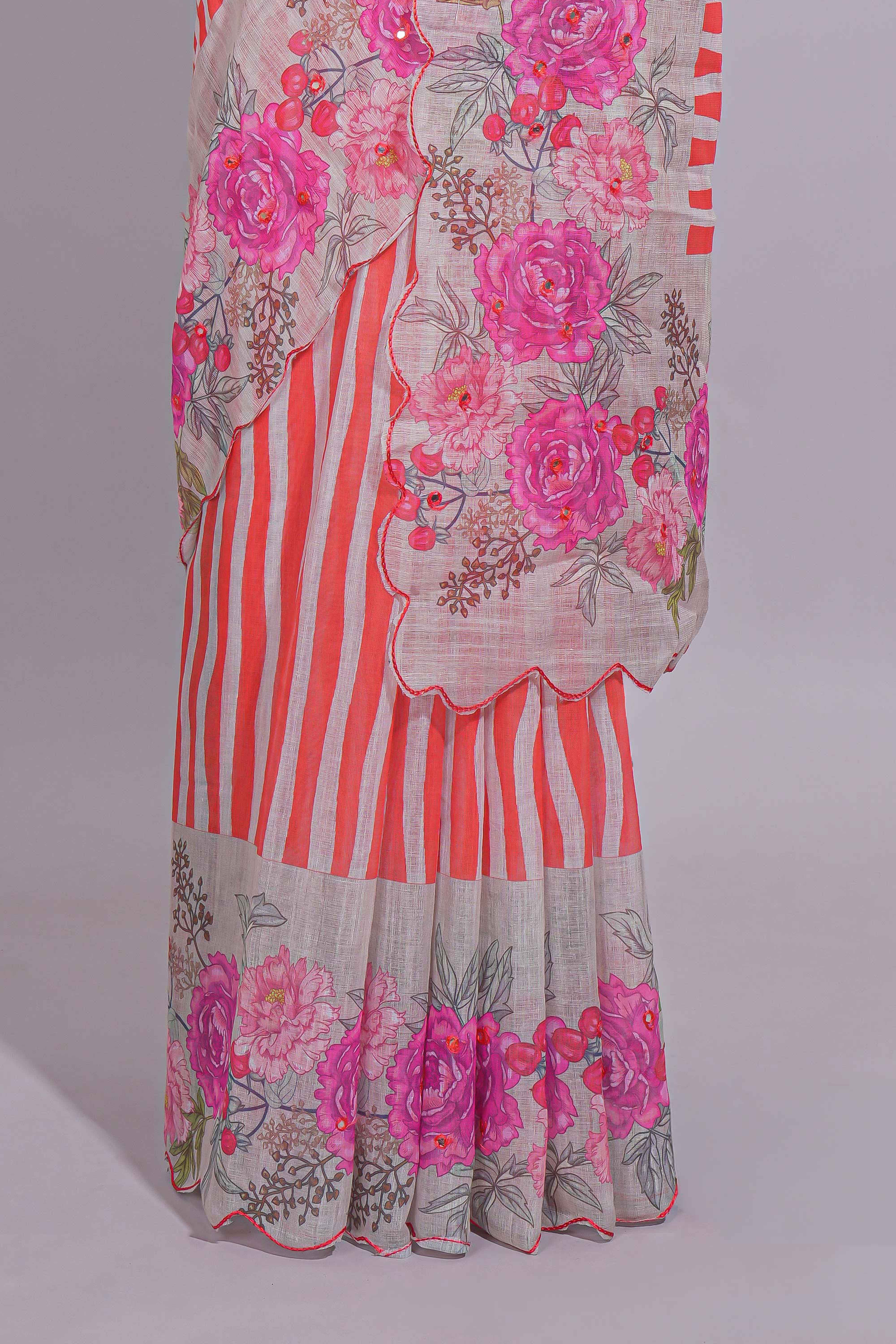White Linen saree with orange stripes and vibrant pink floral scallop border with contrast printed blouse