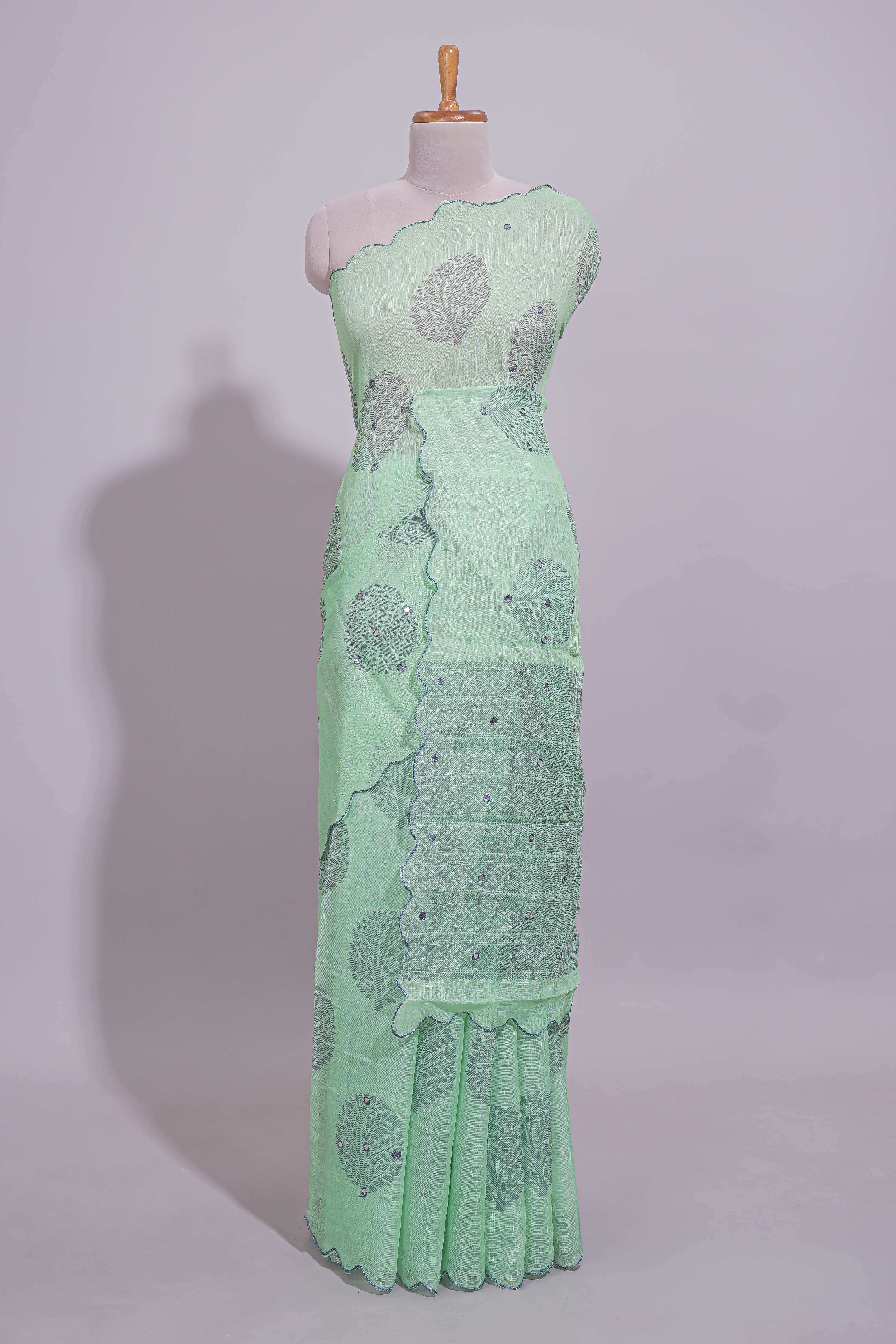 Pastel green linen saree tree motifs and tiny sequin with scalloped border and matching blouse