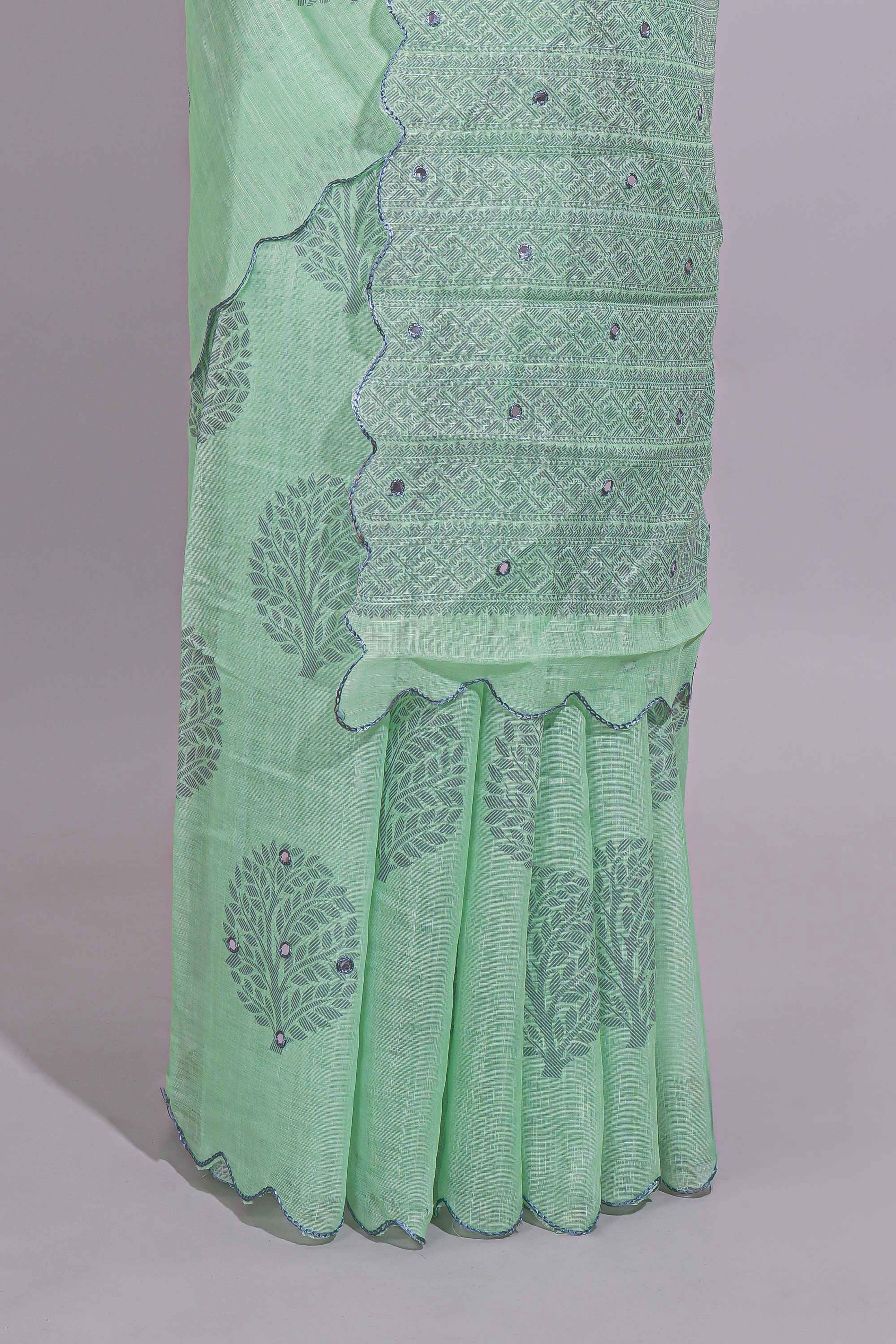 Pastel green linen saree tree motifs and tiny sequin with scalloped border and matching blouse