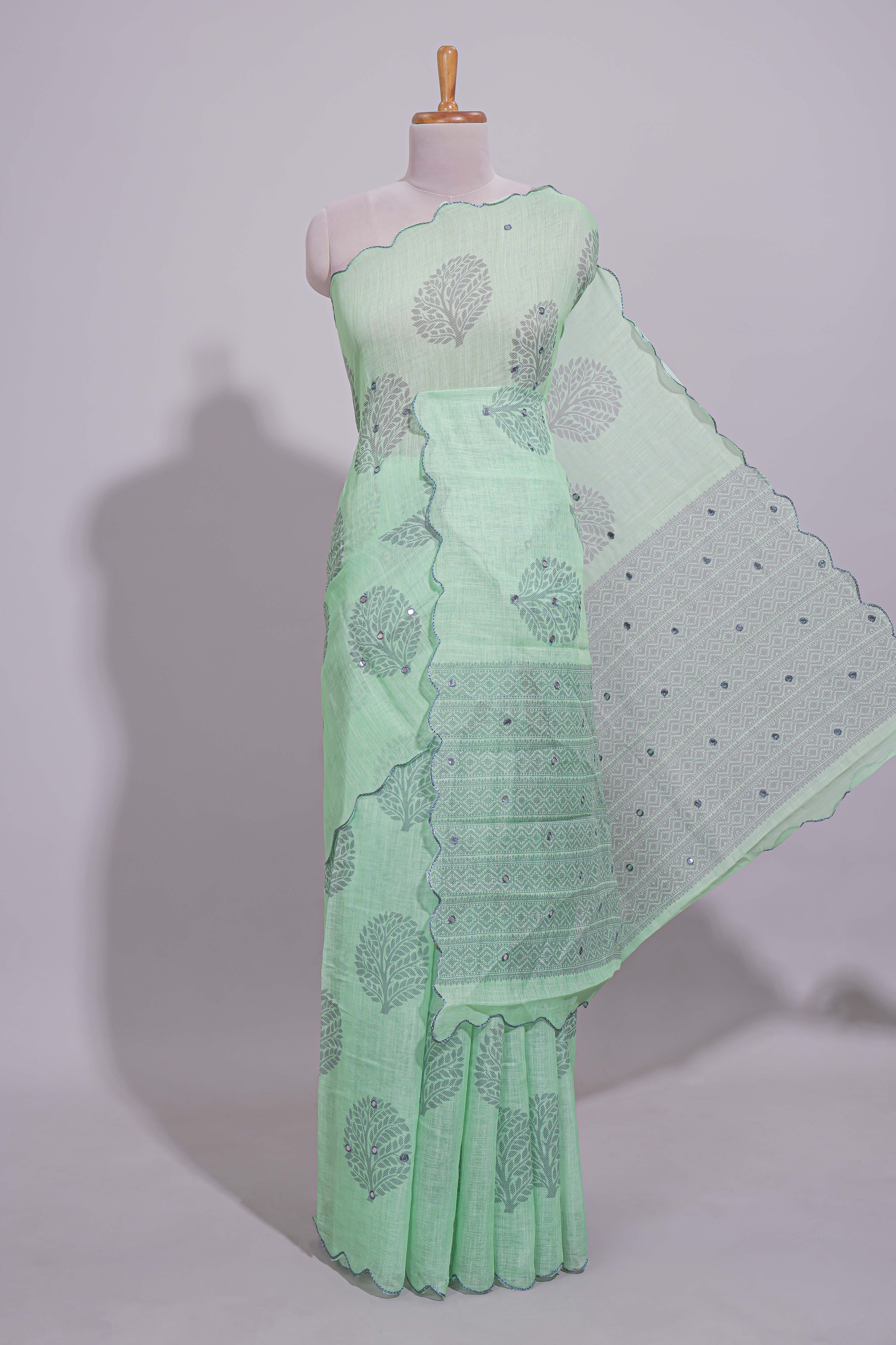 Pastel green linen saree tree motifs and tiny sequin with scalloped border and matching blouse