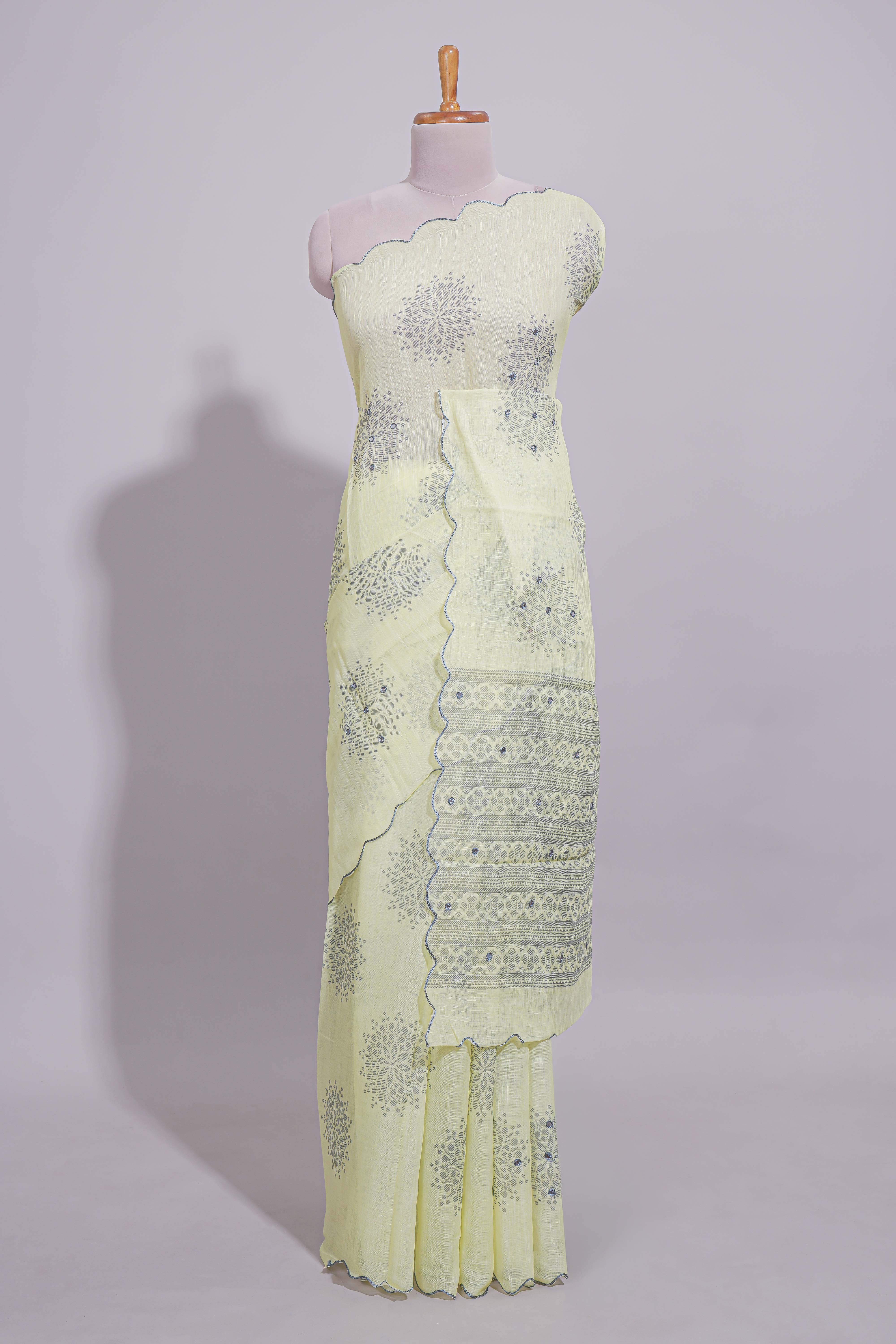 Pastel yellow linen saree tree motifs and tiny sequin with scalloped border and matching blouse