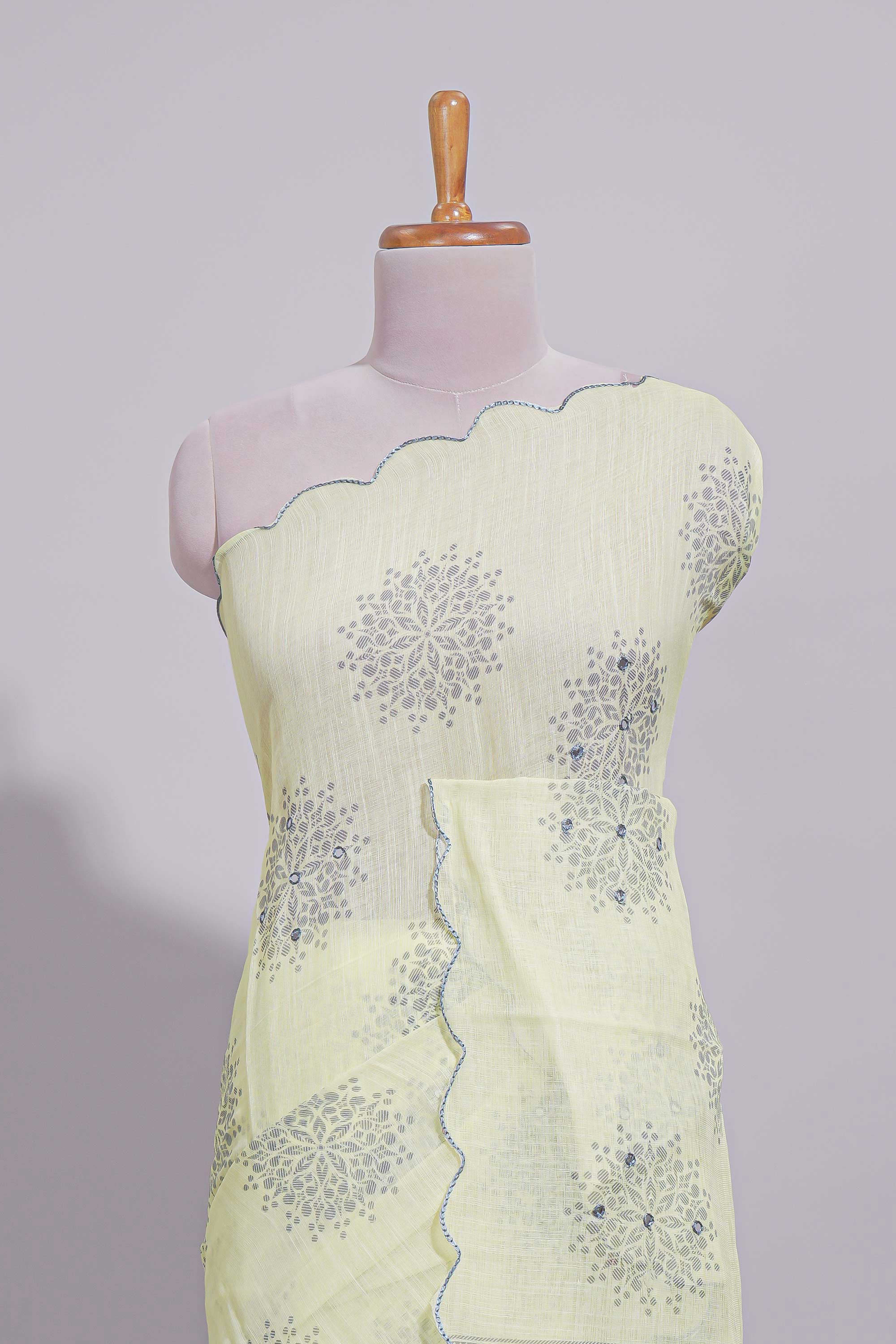Pastel yellow linen saree tree motifs and tiny sequin with scalloped border and matching blouse