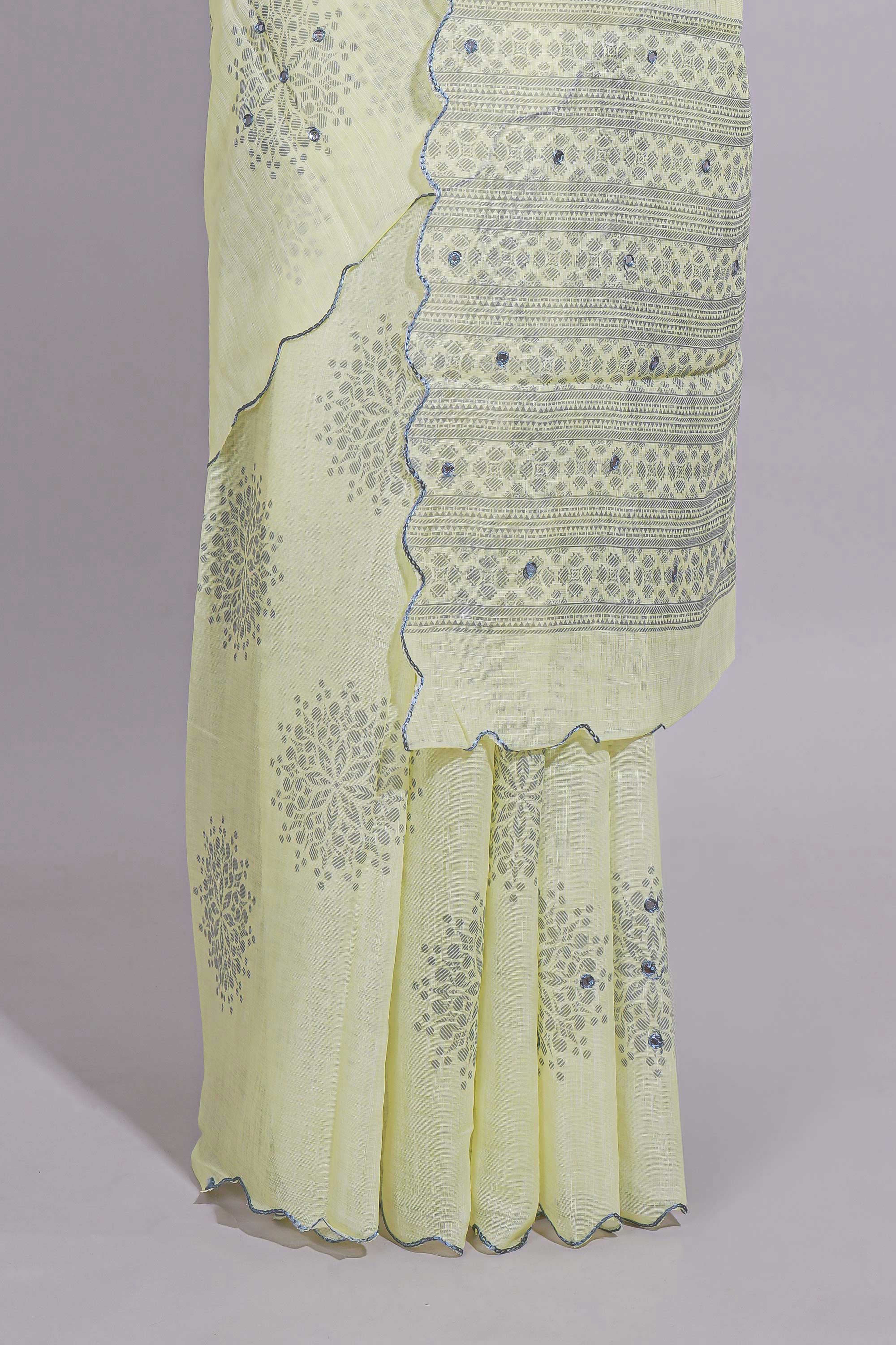 Pastel yellow linen saree tree motifs and tiny sequin with scalloped border and matching blouse