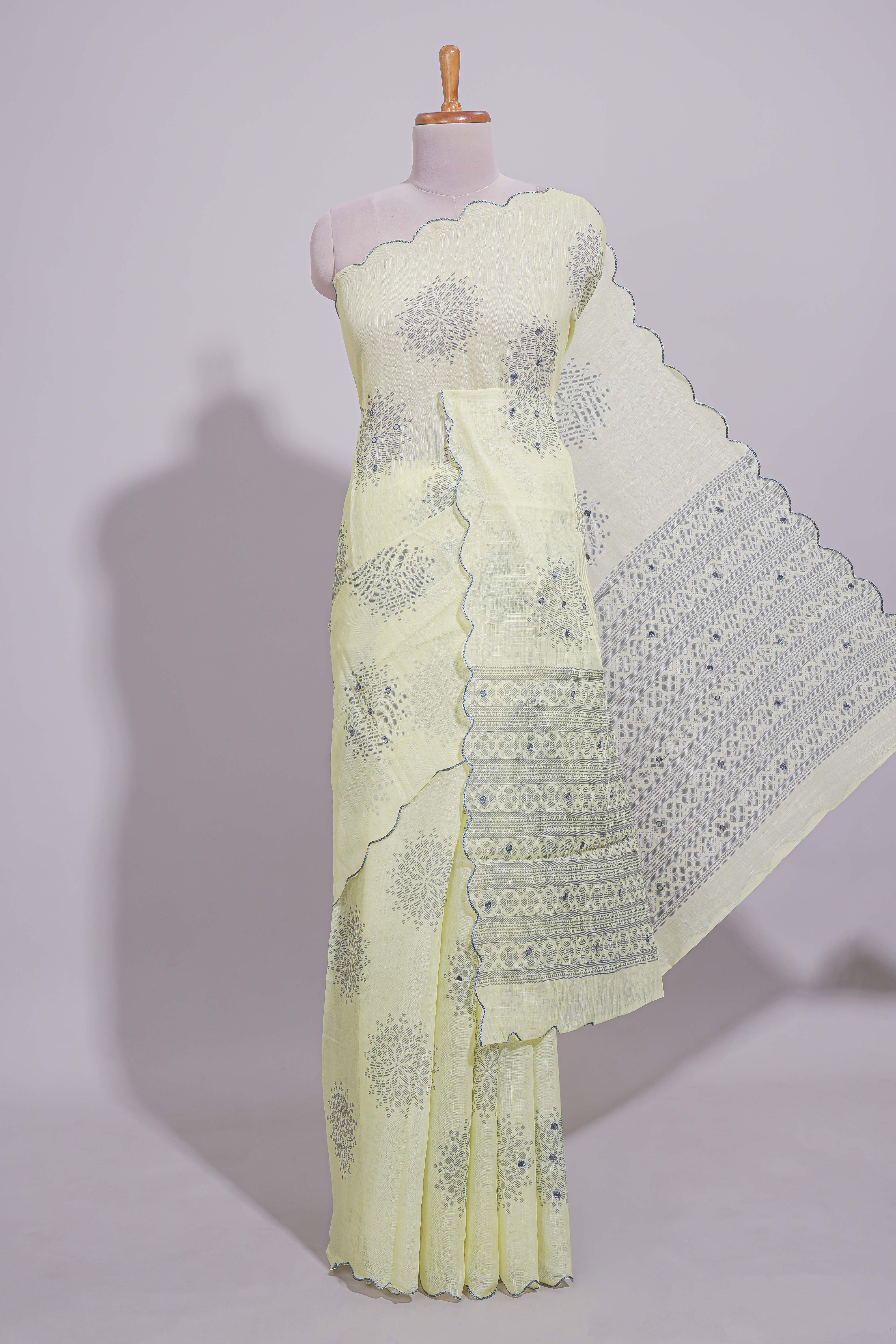 Pastel yellow linen saree tree motifs and tiny sequin with scalloped border and matching blouse