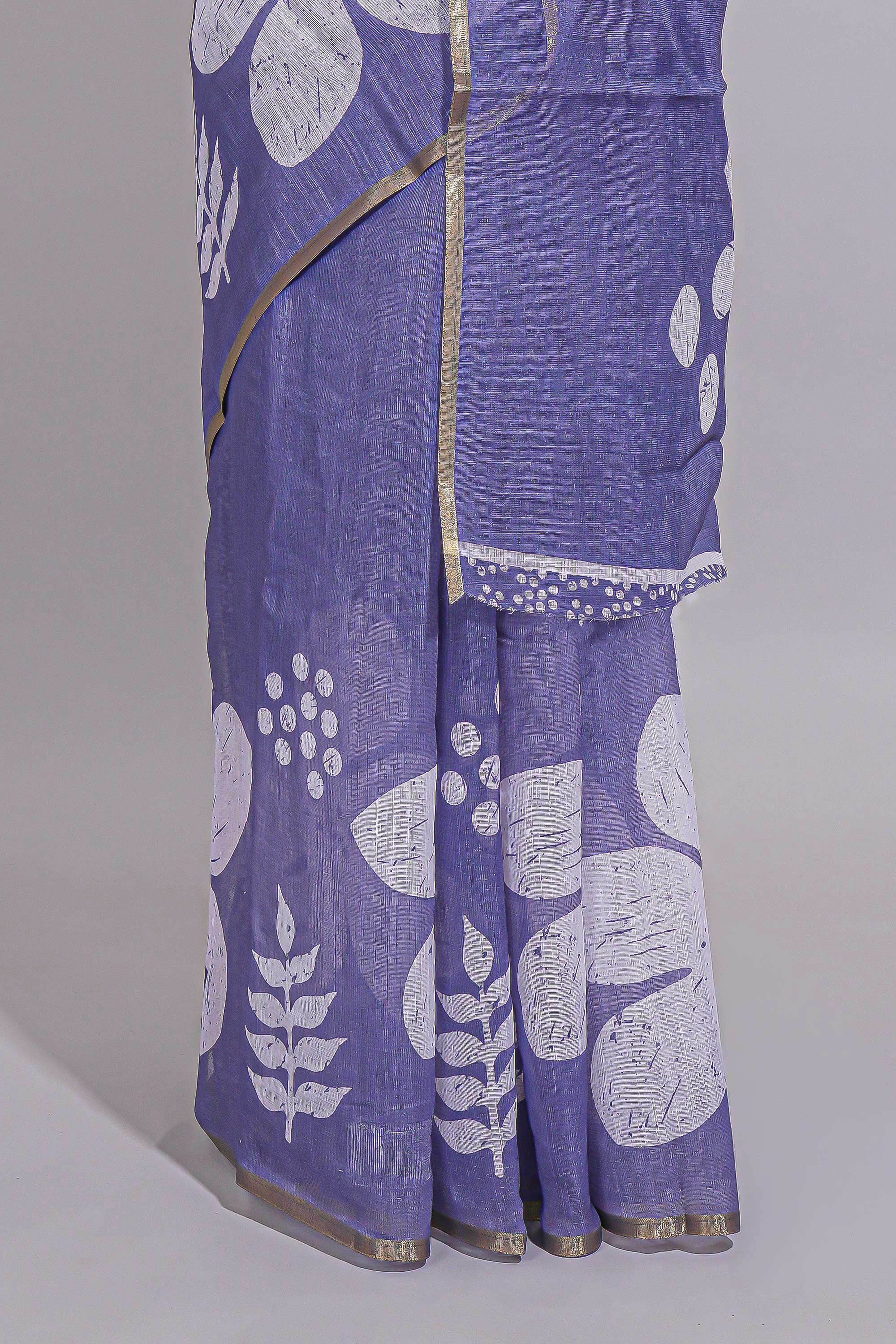 Tropical indigo linen saree with bold white floral and geometric prints finished with a subtle metallic border along with matching blouse