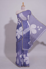 Tropical indigo linen saree with bold white floral and geometric prints finished with a subtle metallic border along with matching blouse