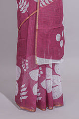 Rani pink linen saree with bold white floral and geometric prints finished with a subtle metallic border along with matching blouse