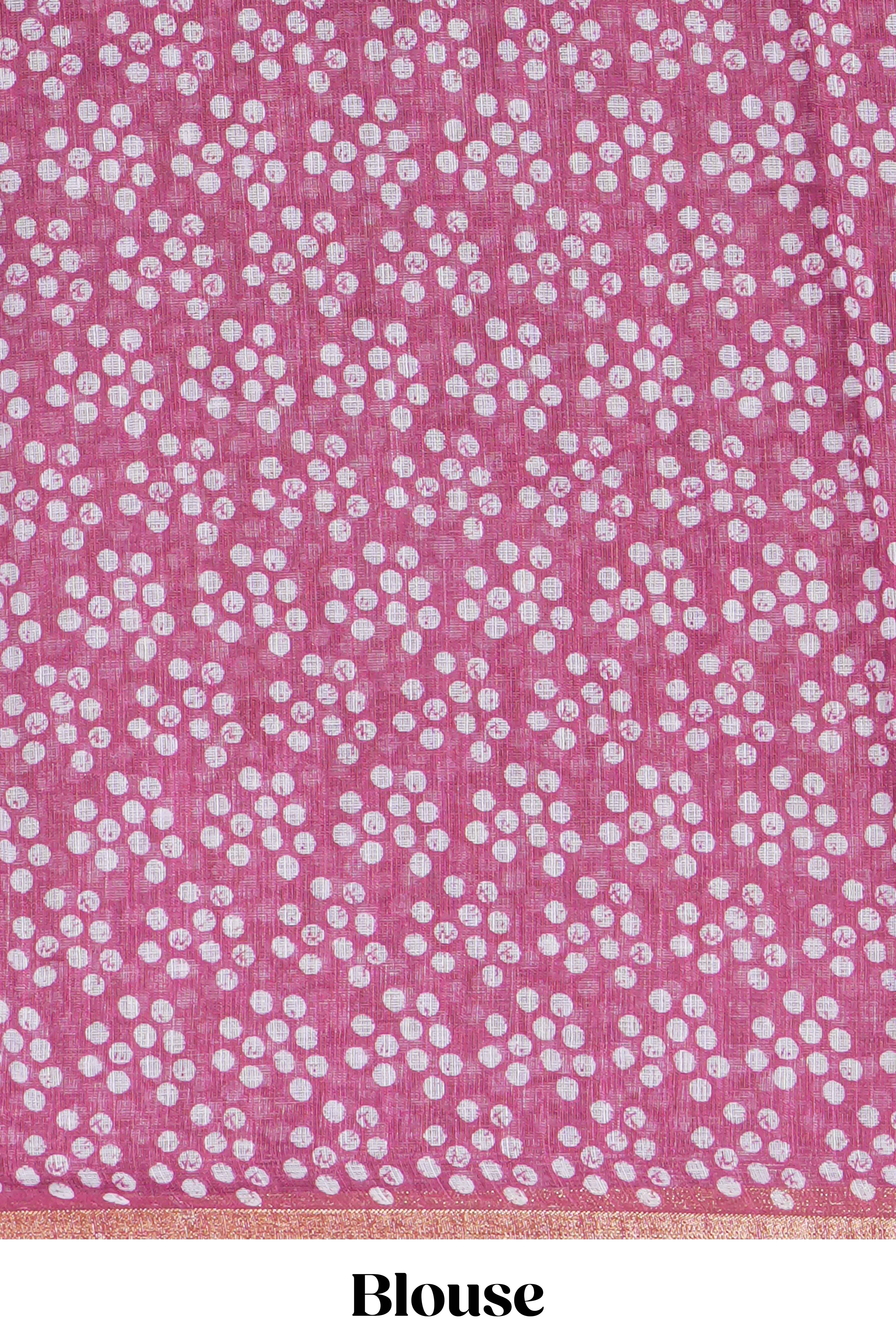 Rani pink linen saree with bold white floral and geometric prints finished with a subtle metallic border along with matching blouse