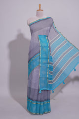 Checked linen saree with contrast blue border and pallu along with contrast printed blouse
