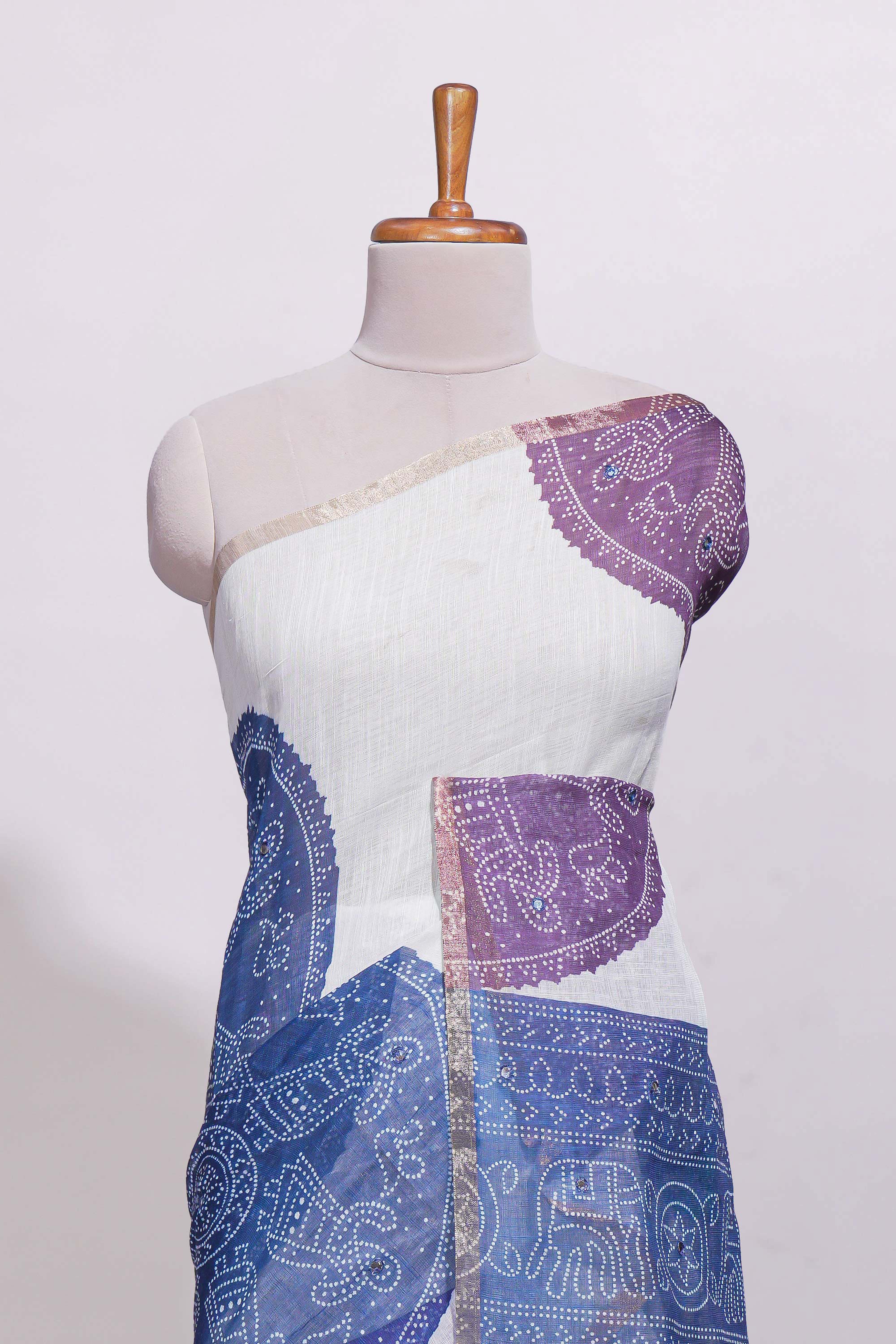 White bandhini designed linen cotton saree with self border and contrast blue blouse