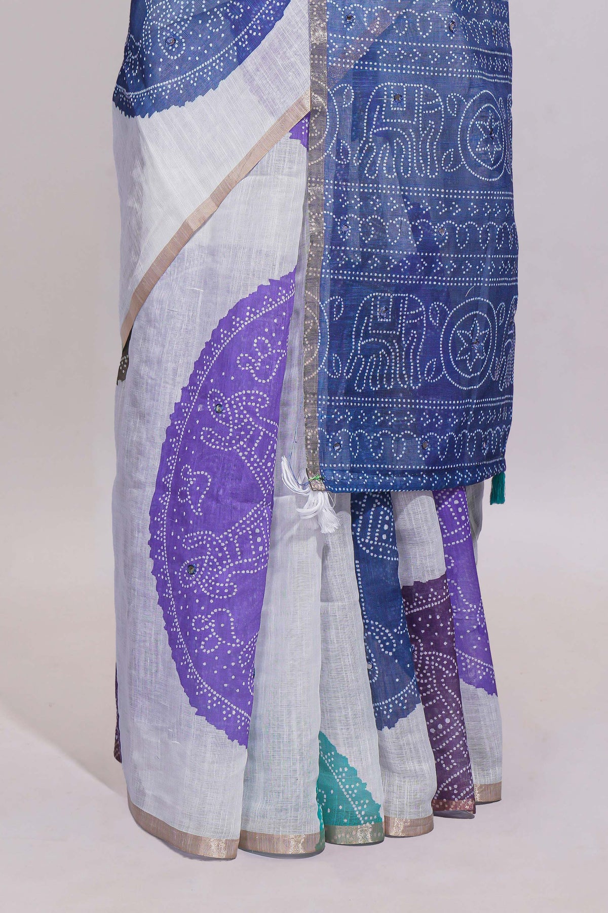 White bandhini designed linen cotton saree with self border and contrast blue blouse