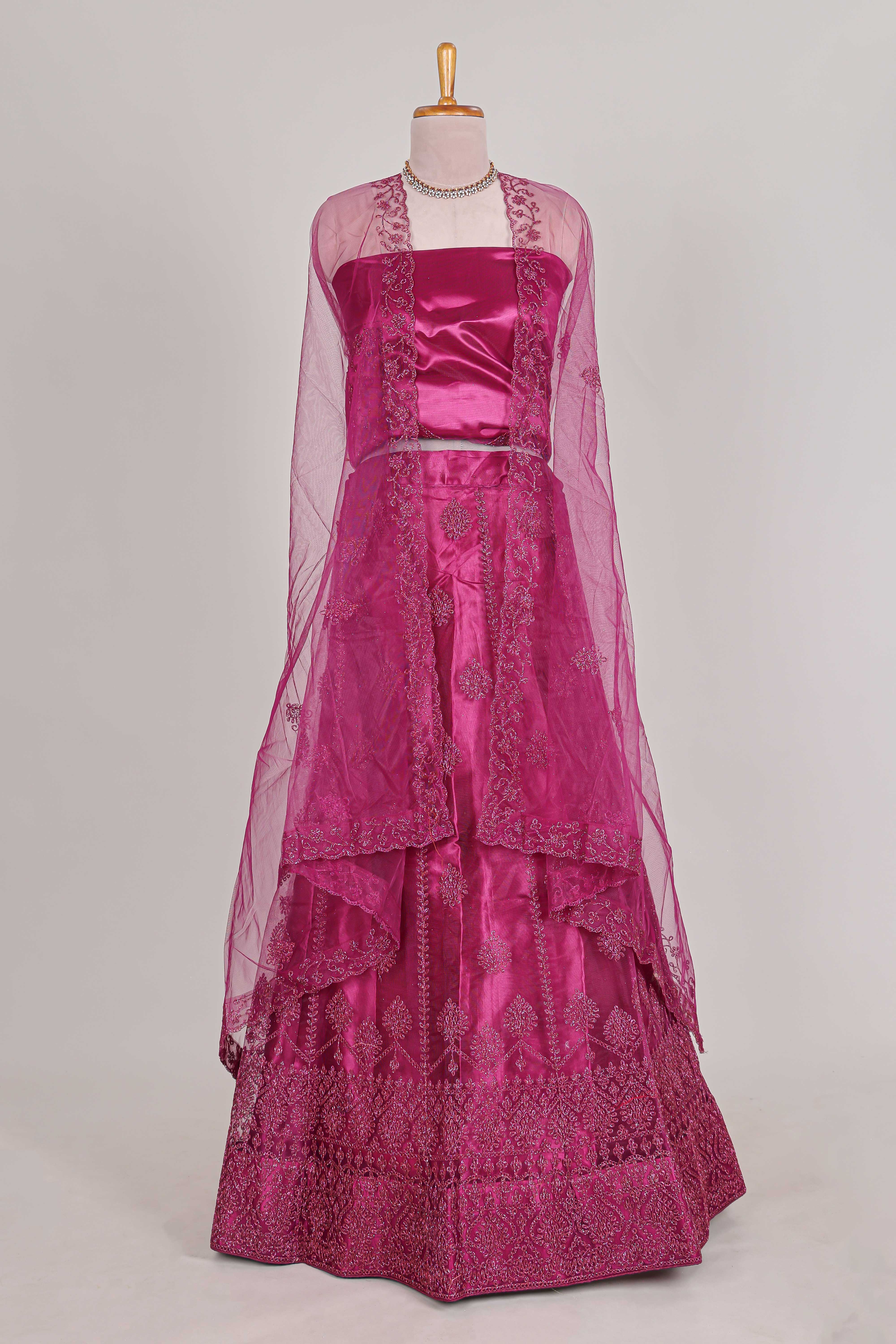 Rose colour net lehenga featuring delicate embroidery with a borderless design paired with a matching self shawl