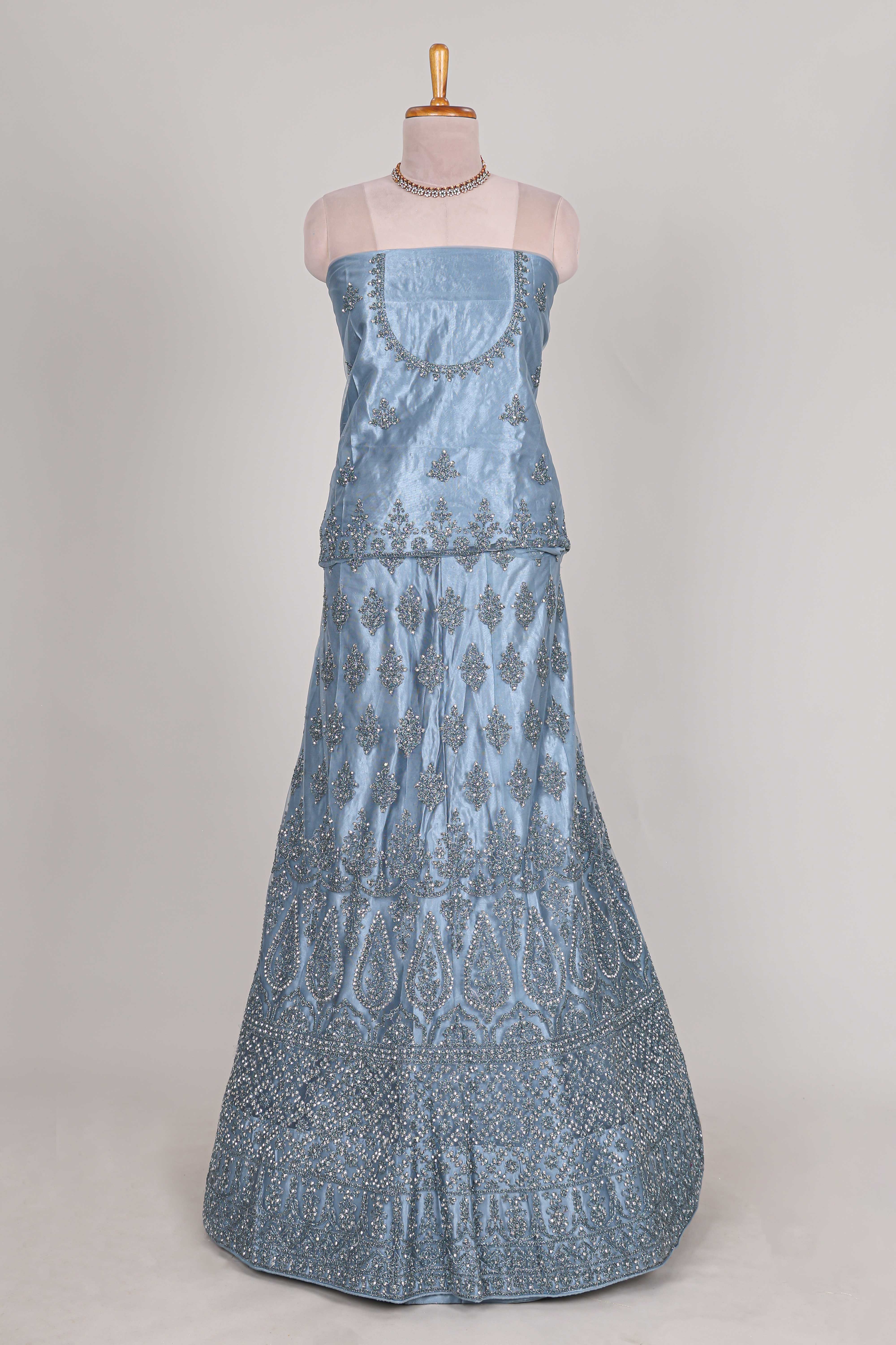 Sea blue colour net lehenga featuring delicate embroidery stone work with a borderless design paired with a matching self shawl