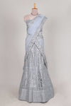 Silver colour net lehenga featuring delicate embroidery stone work with a borderless design paired with a matching self shawl