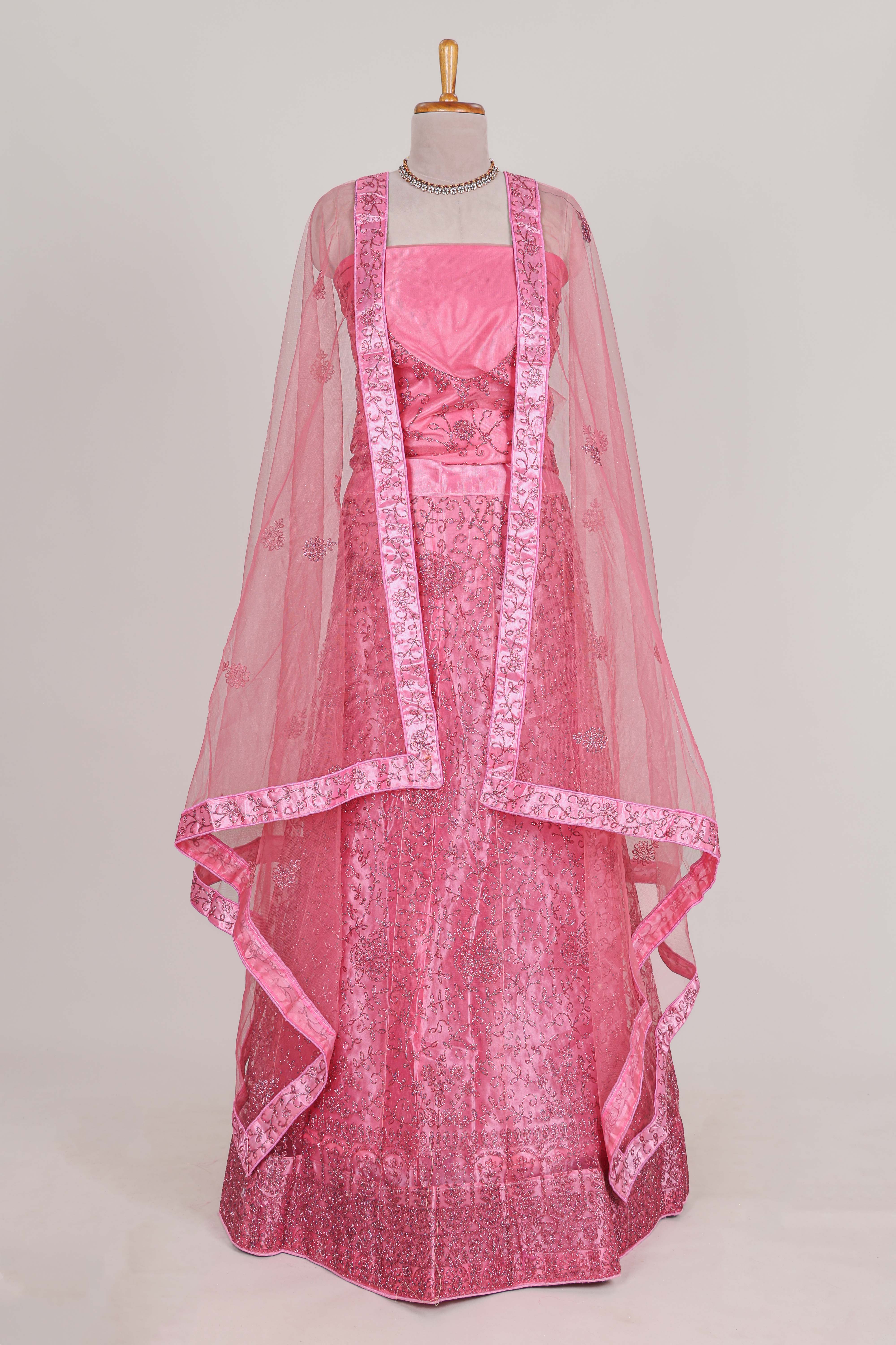 Pink net lehenga featuring delicate embroidery with a borderless design paired with a matching self shawl