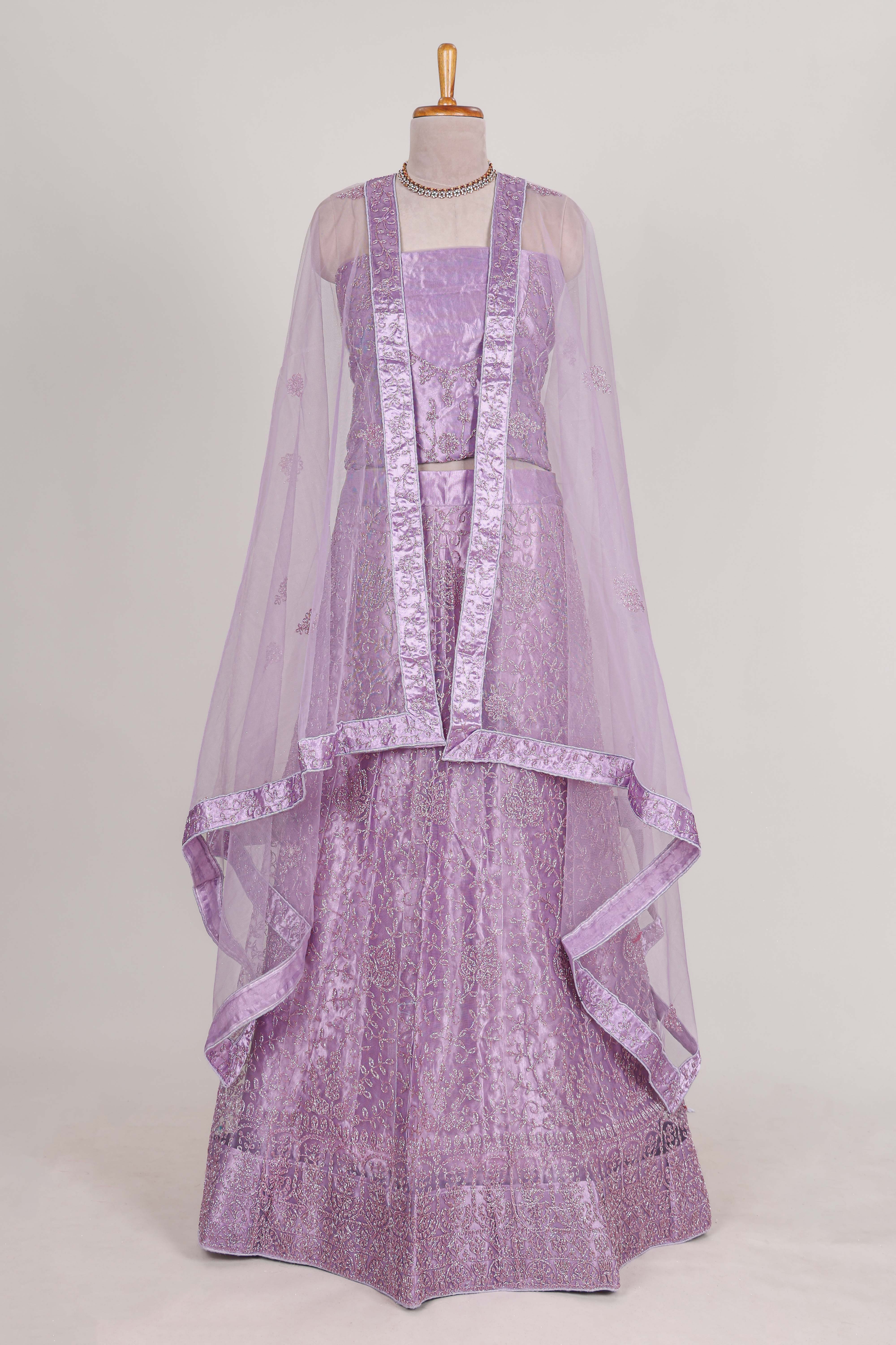 Lavender net lehenga featuring delicate embroidery with a borderless design paired with a matching self shawl