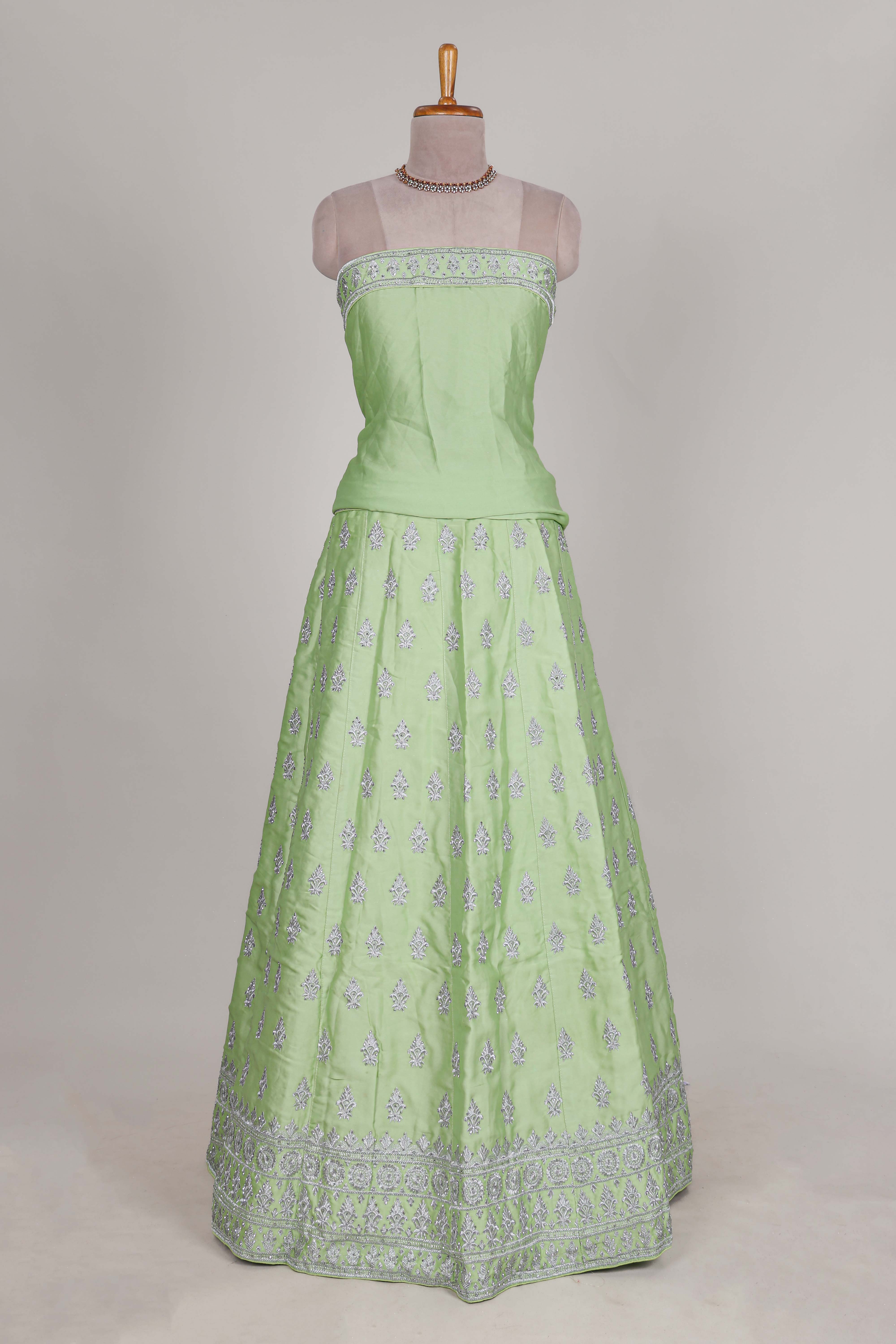 Powder green satin lehenga featuring delicate embroidery with a bordered design paired with a matching self shawl