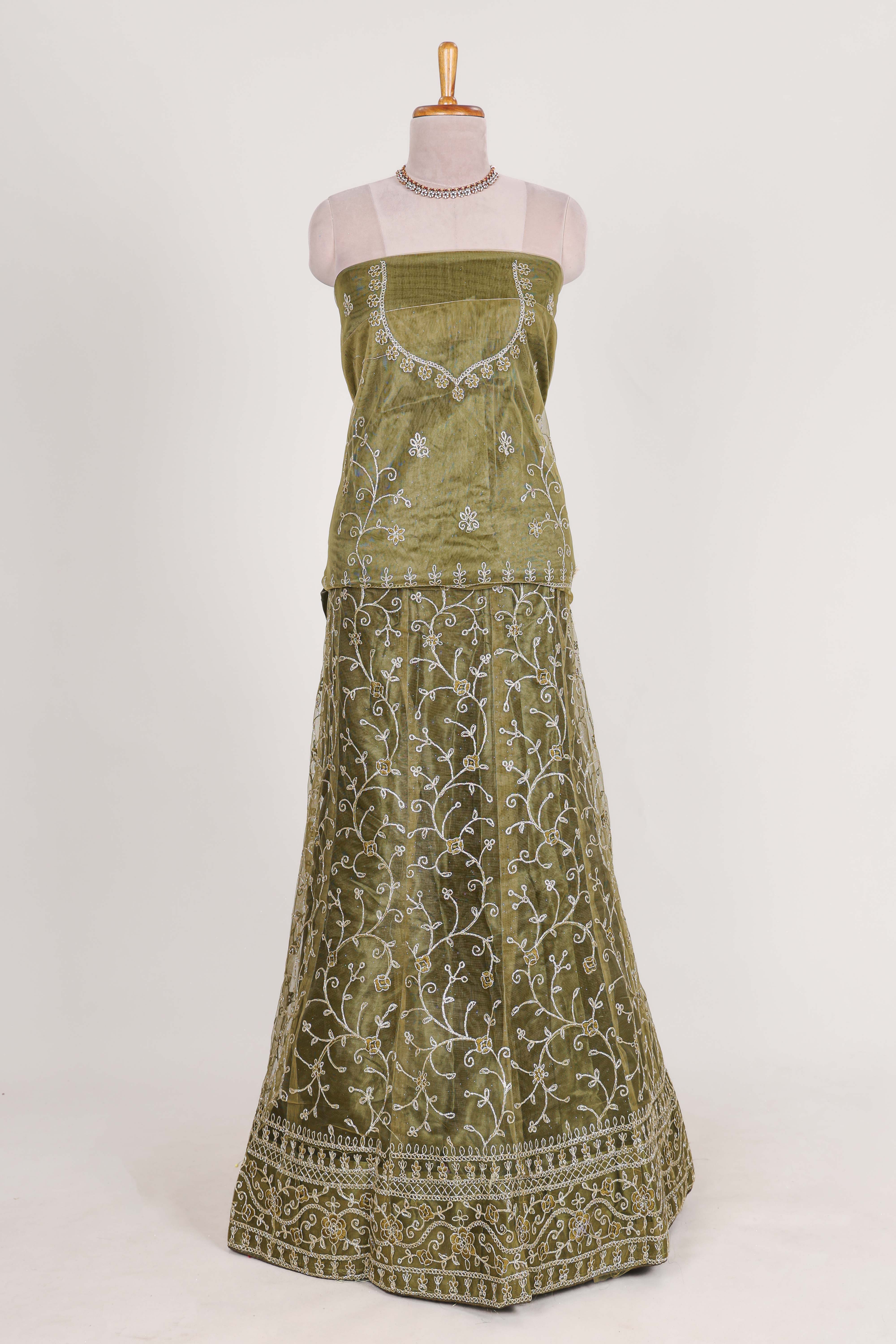 Olive Green net lehenga featuring delicate embroidery with a borderless design paired with a matching self shawl