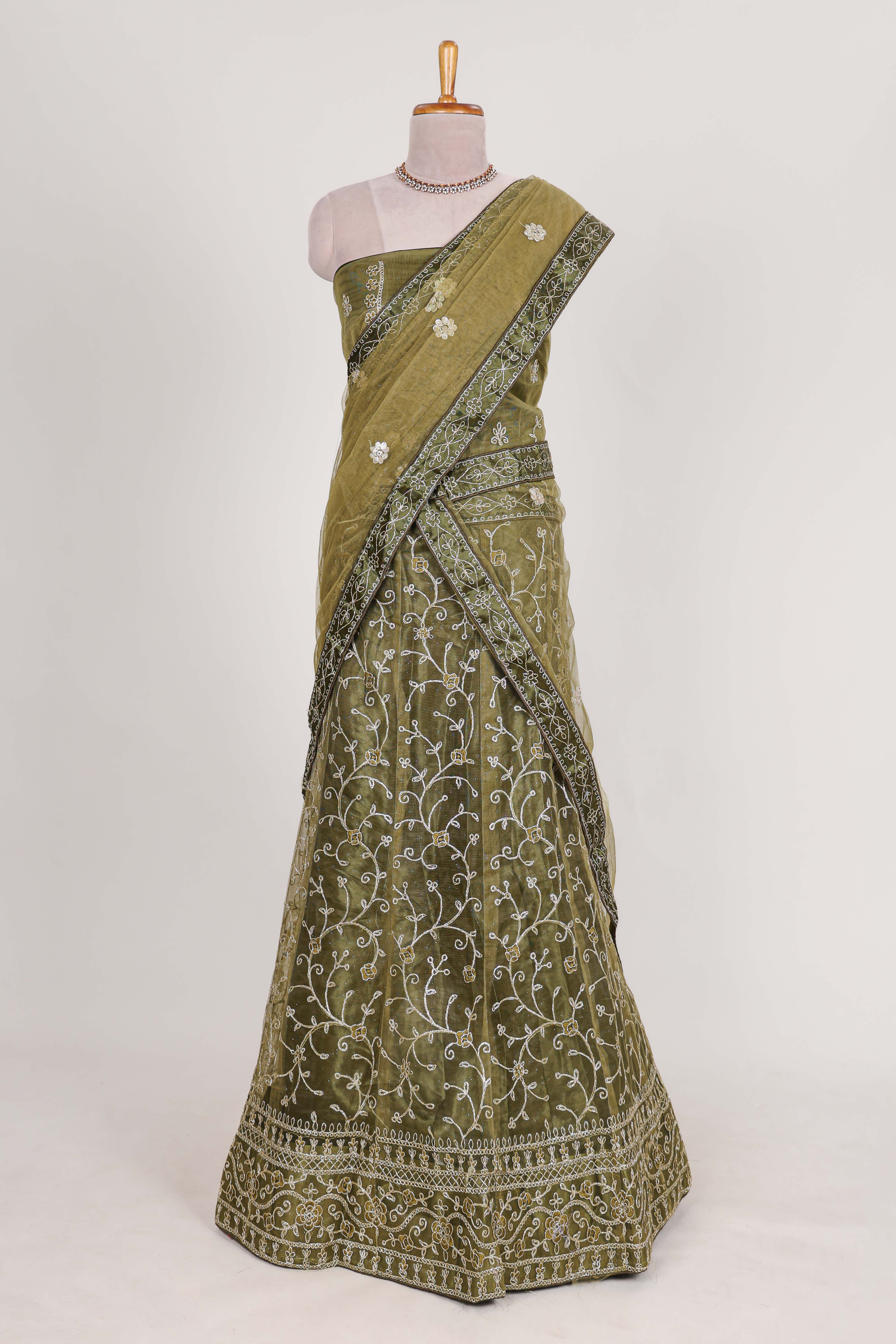 Olive Green net lehenga featuring delicate embroidery with a borderless design paired with a matching self shawl