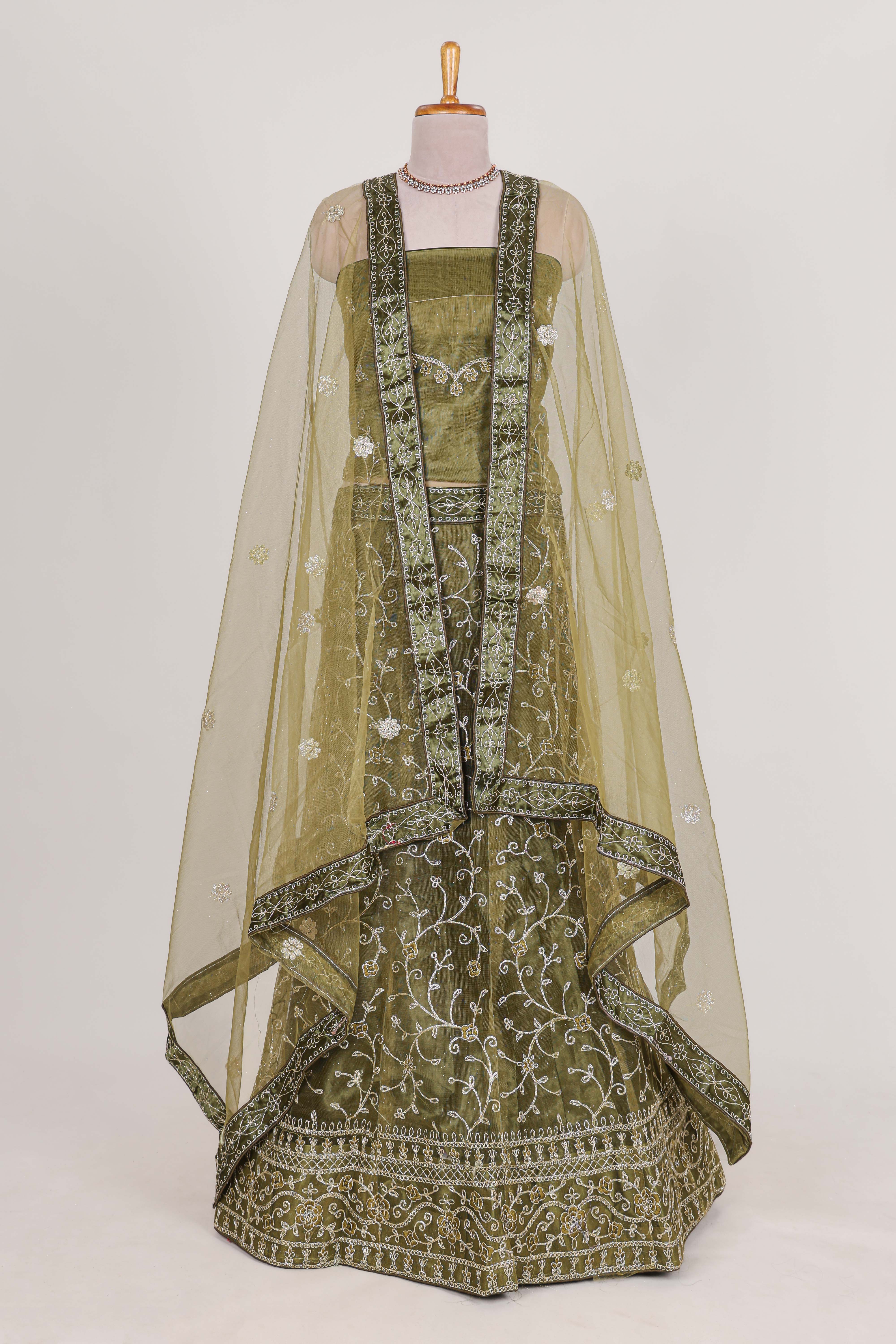 Olive Green net lehenga featuring delicate embroidery with a borderless design paired with a matching self shawl