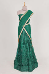 Bottle Green net lehenga featuring delicate embroidery with a borderless design paired with a matching self shawl