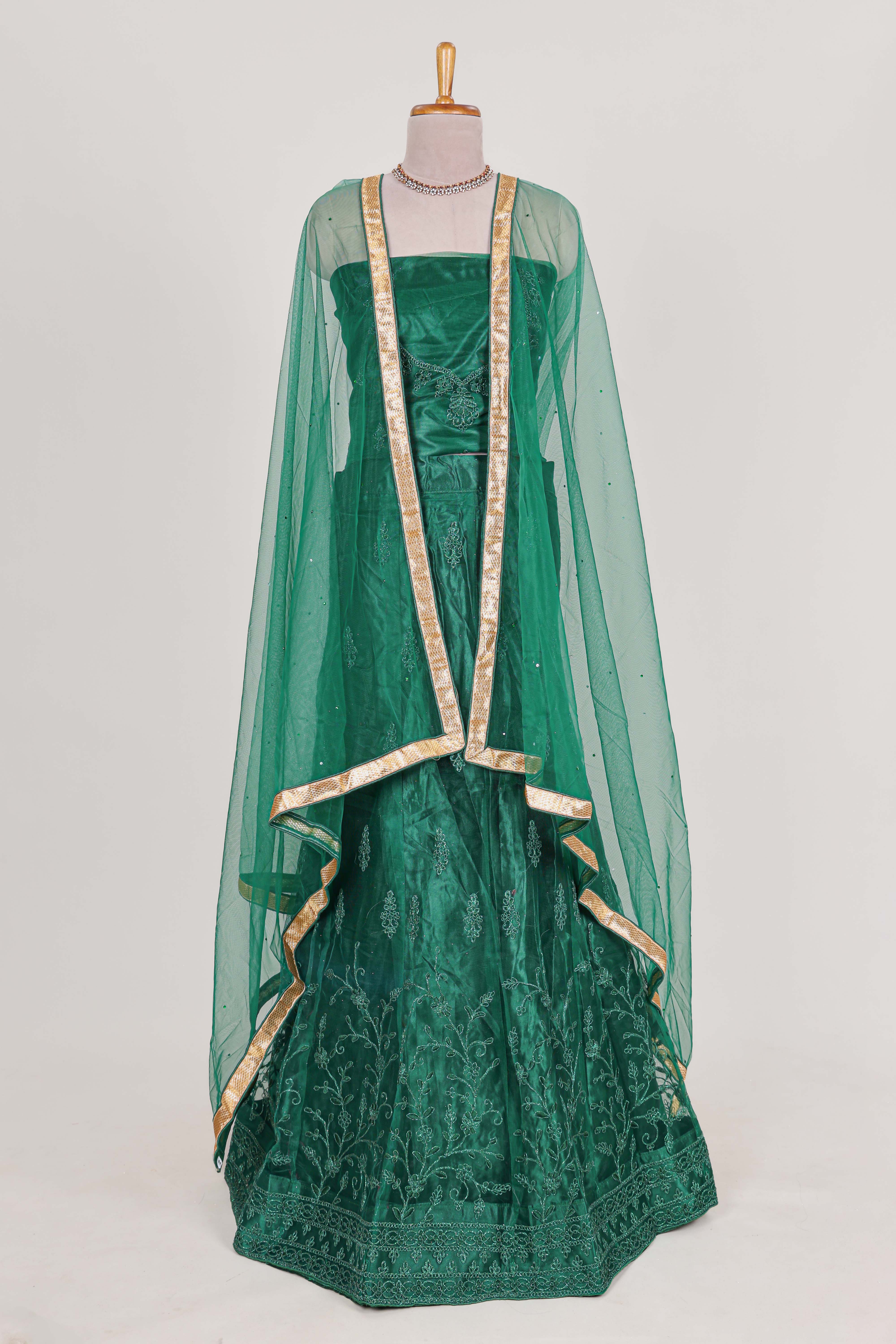 Bottle Green net lehenga featuring delicate embroidery with a borderless design paired with a matching self shawl