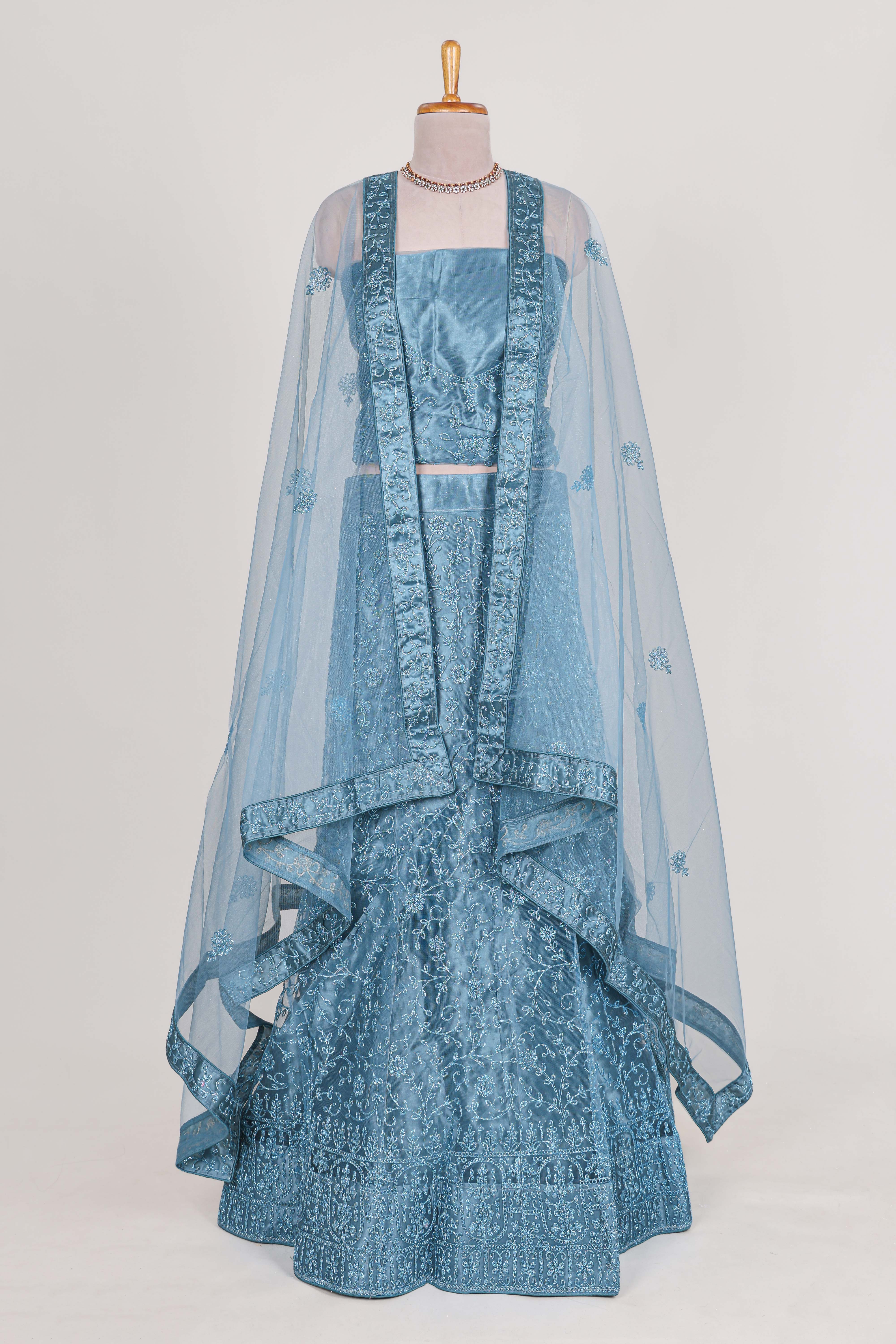 Blue colour net lehenga featuring delicate embroidery with a borderless design paired with a matching self shawl
