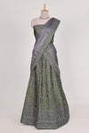 green satin lehenga featuring delicate embroidery with a bordered design paired with contrast shawl