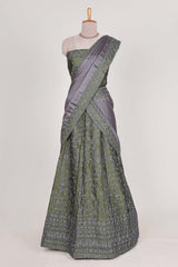 green satin lehenga featuring delicate embroidery with a bordered design paired with contrast shawl