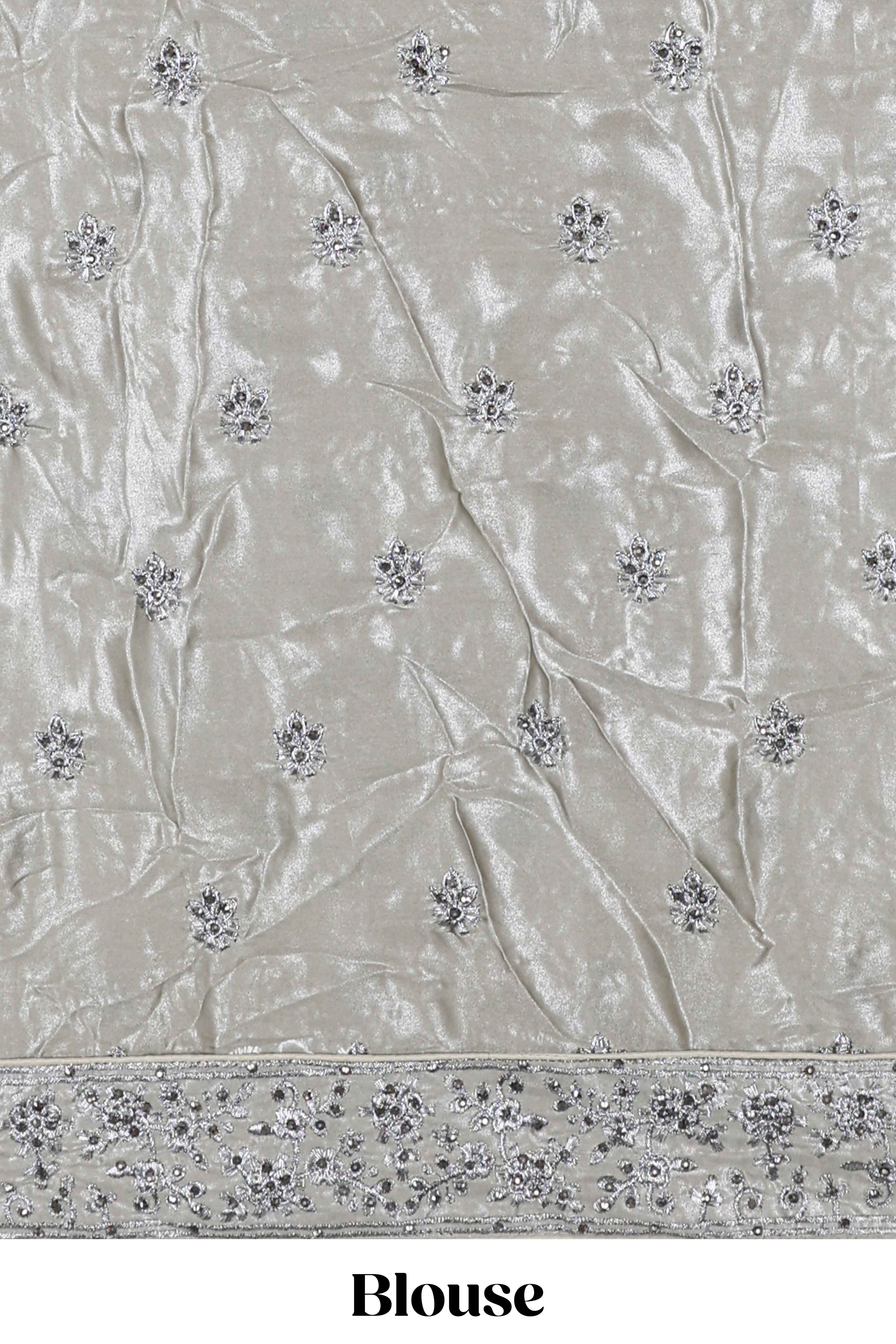 Silver satin lehenga featuring delicate embroidery with a bordered design paired with contrast shawl