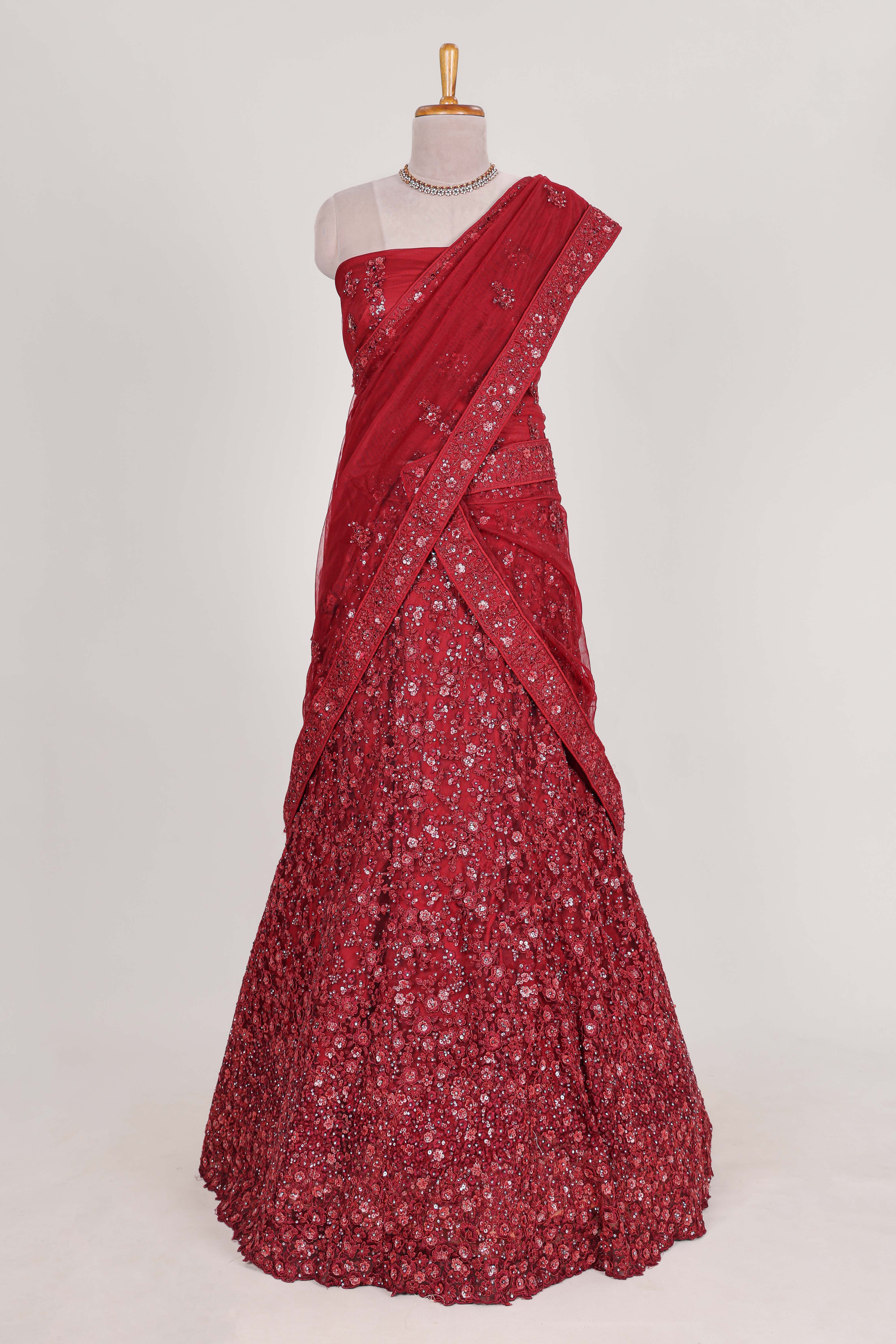 Beautiful net lehenga adorned with intricate embroidery Paired with a matching net shawl perfect for weddings and special occasions